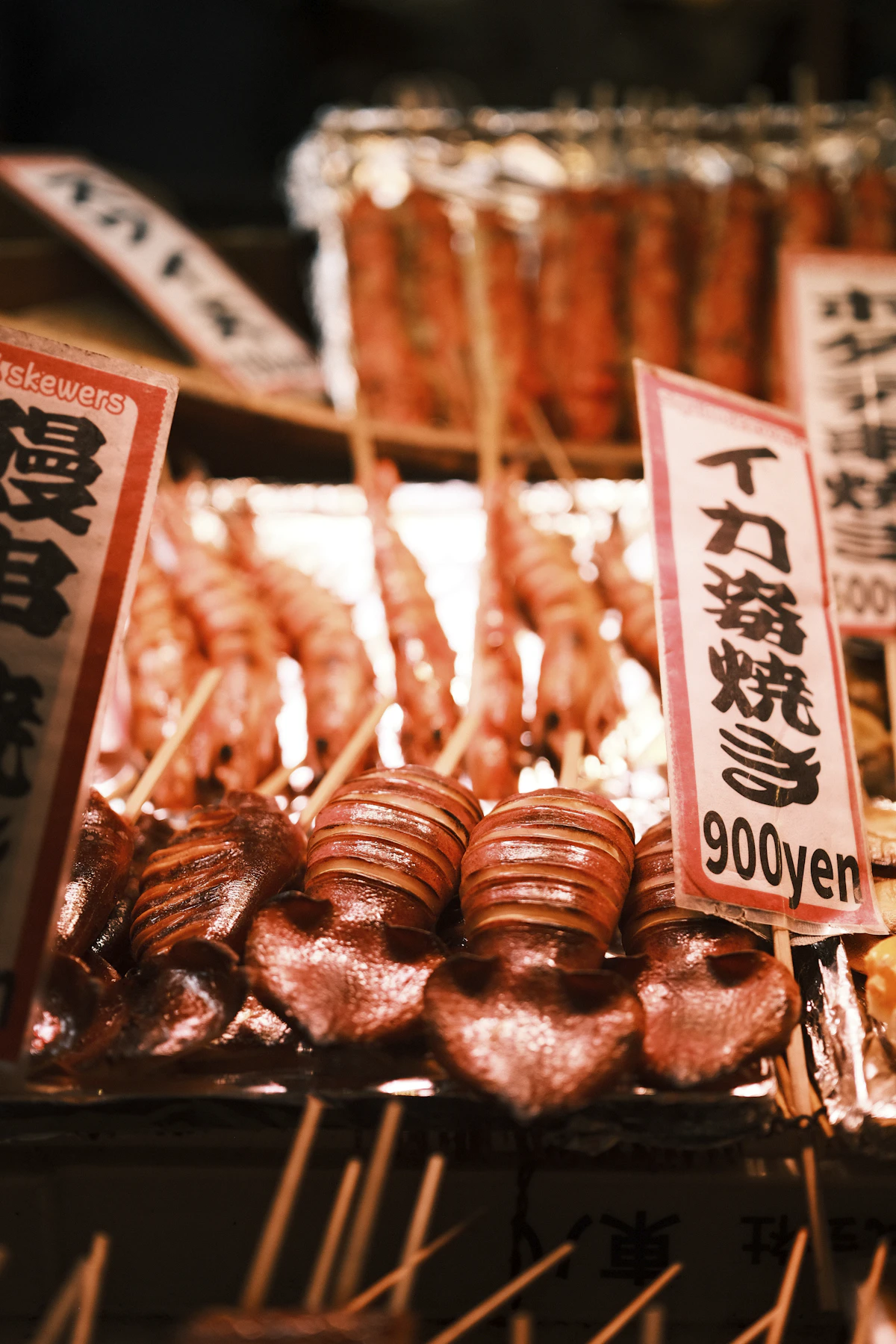 Skewered grilled squid and shrimp at a Japanese market stall