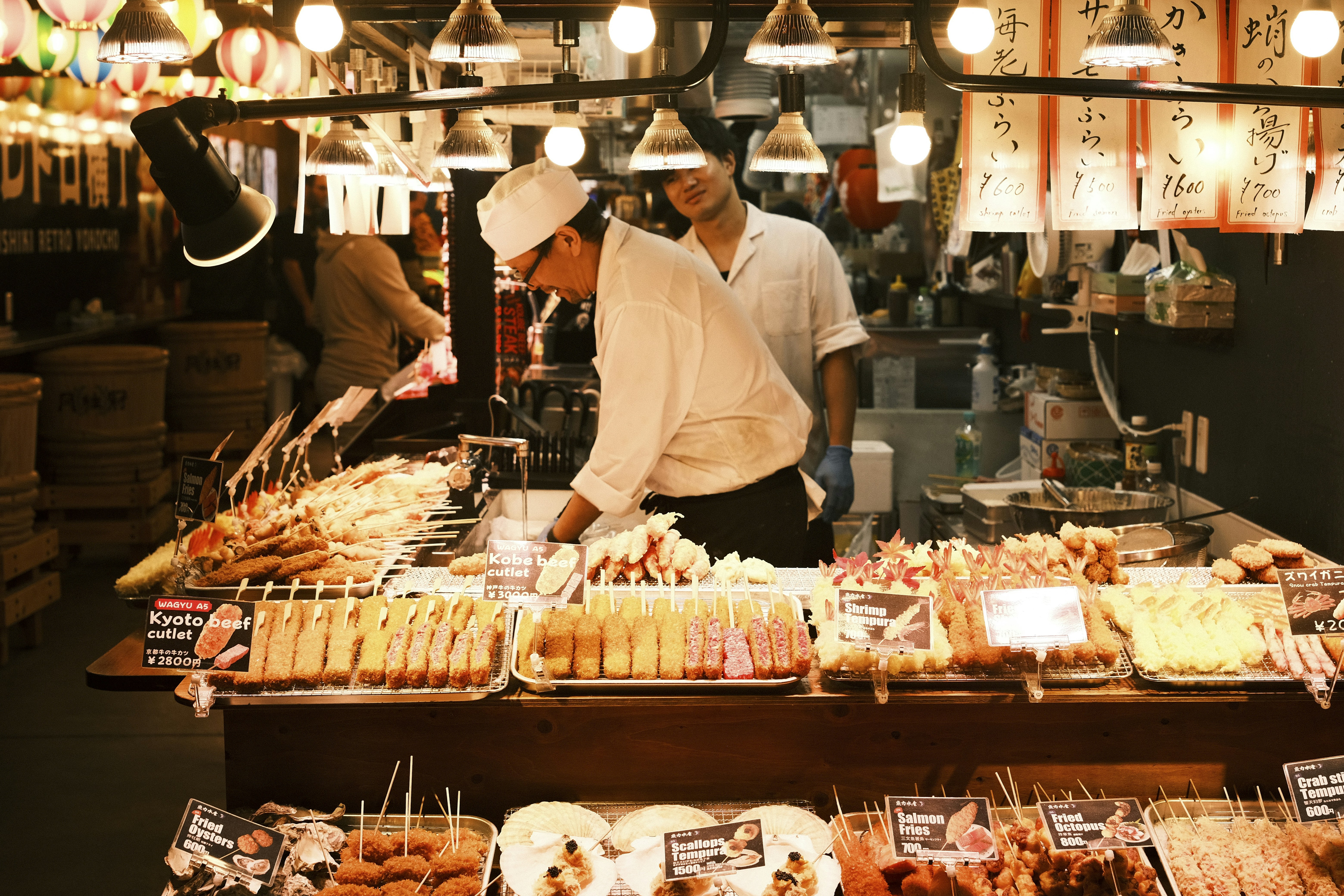 Vendors selling skewers at a bustling market