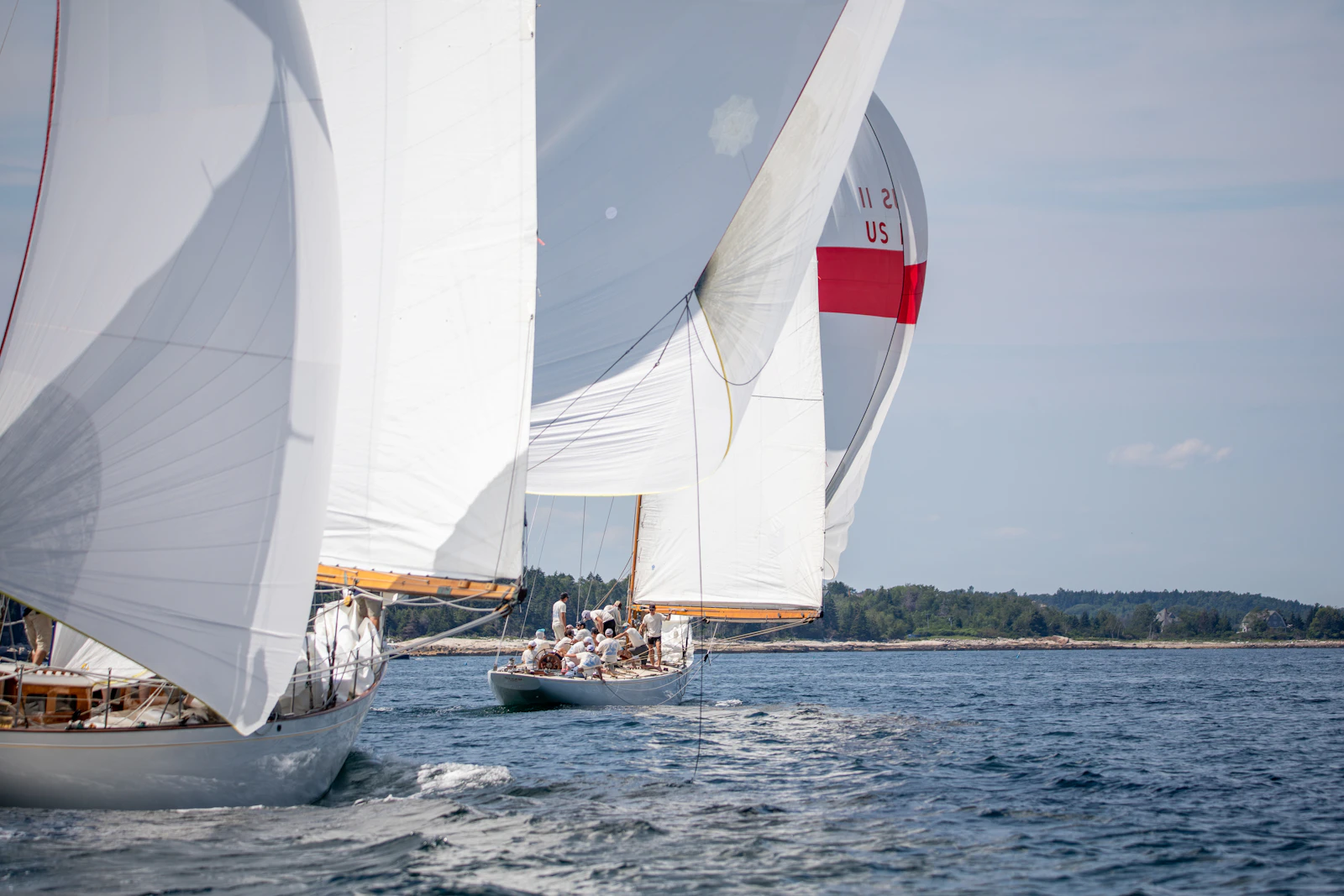 Sailboats racing across deep blue ocean