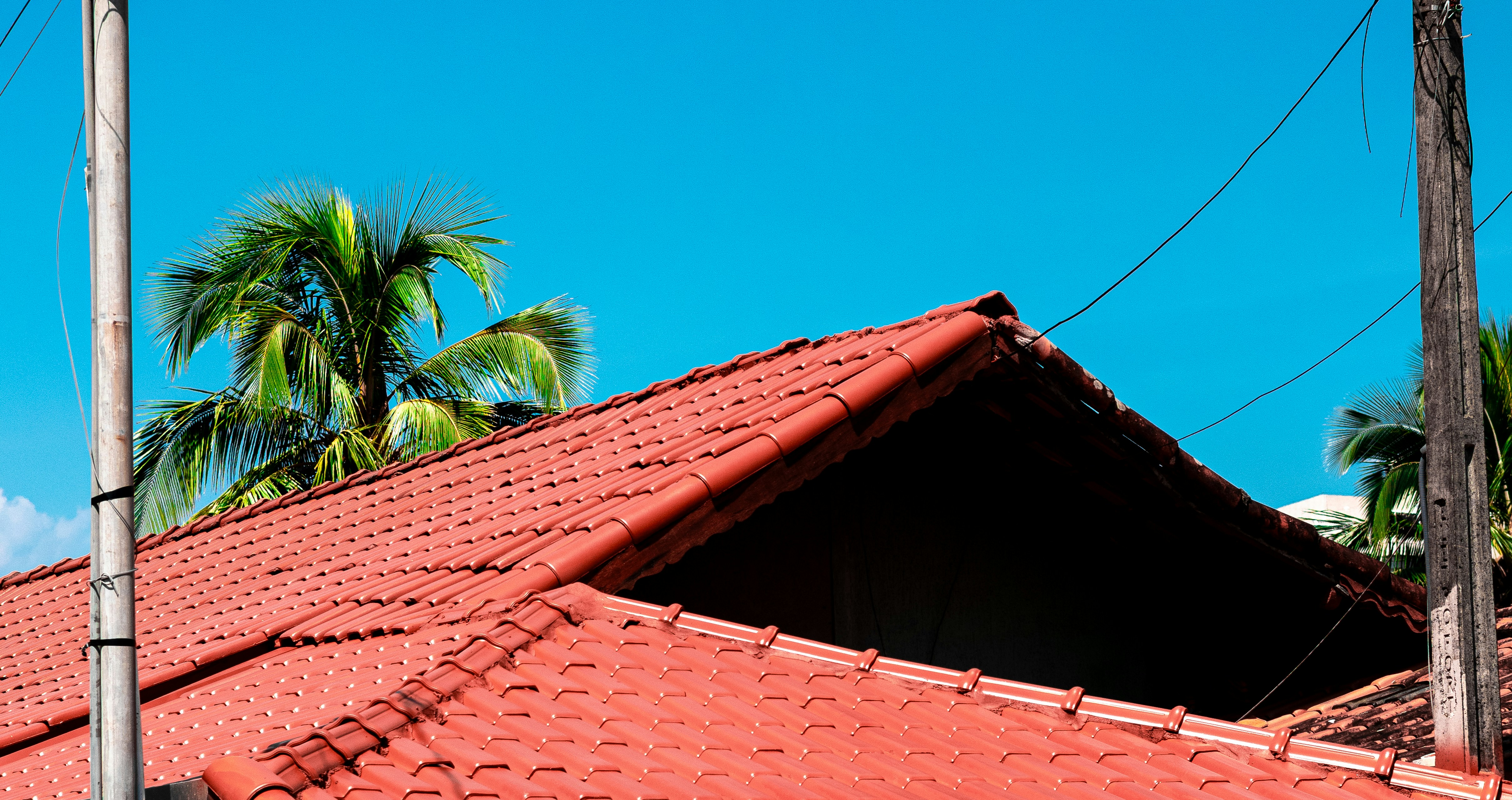 Red tiled roof against a bright blue sky