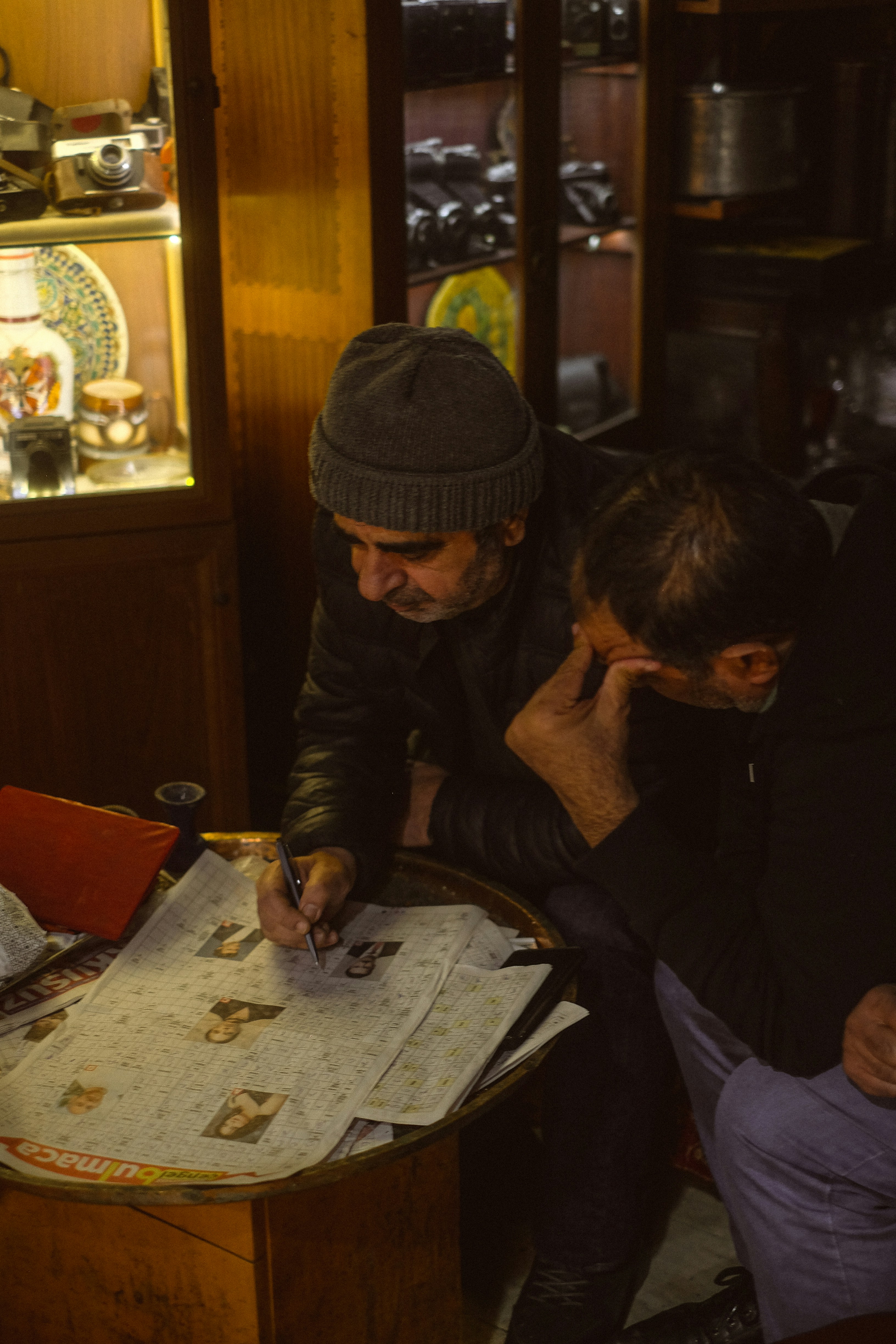 Two men looking at a newspaper