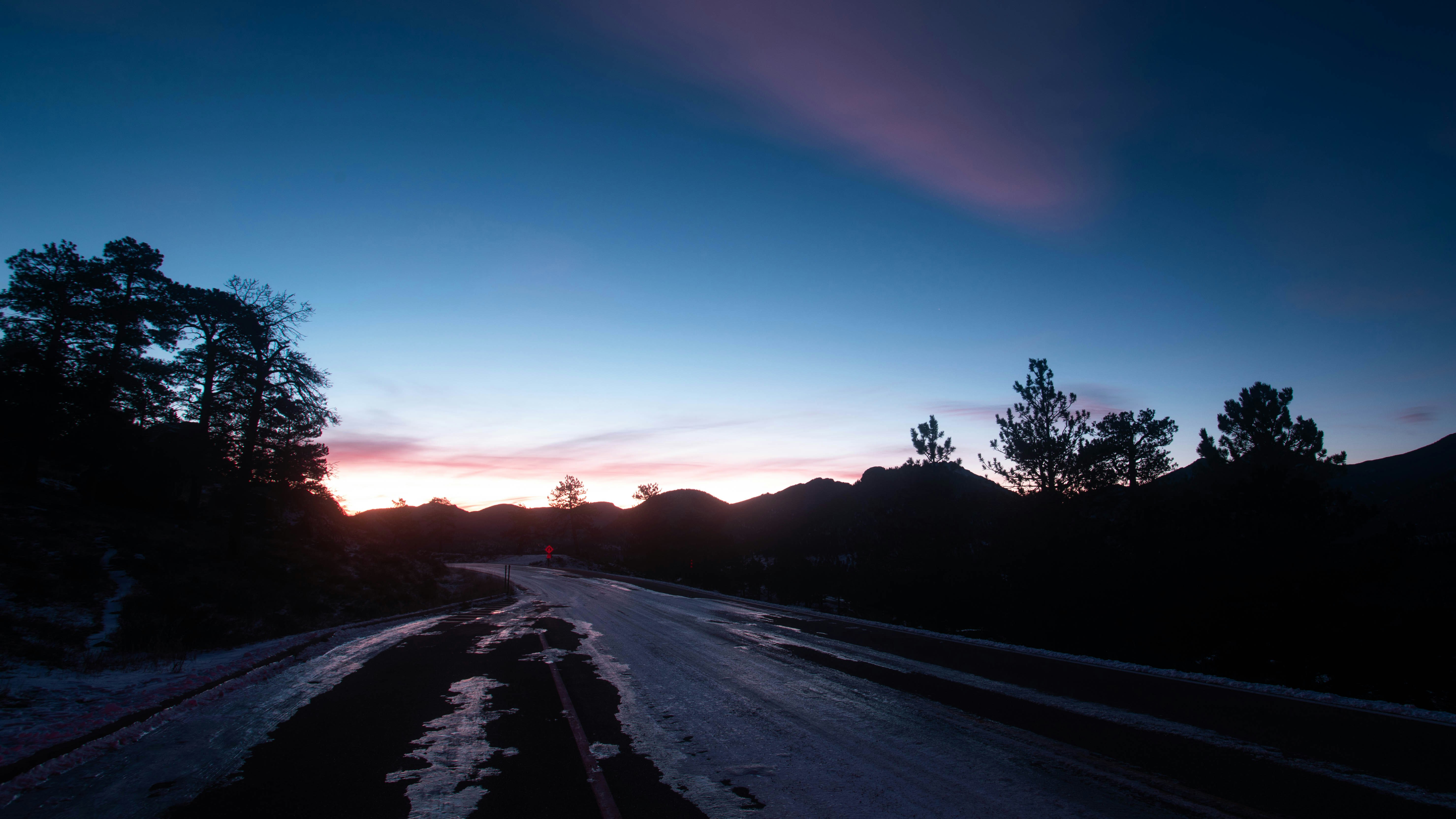 A road through mountains at dusk