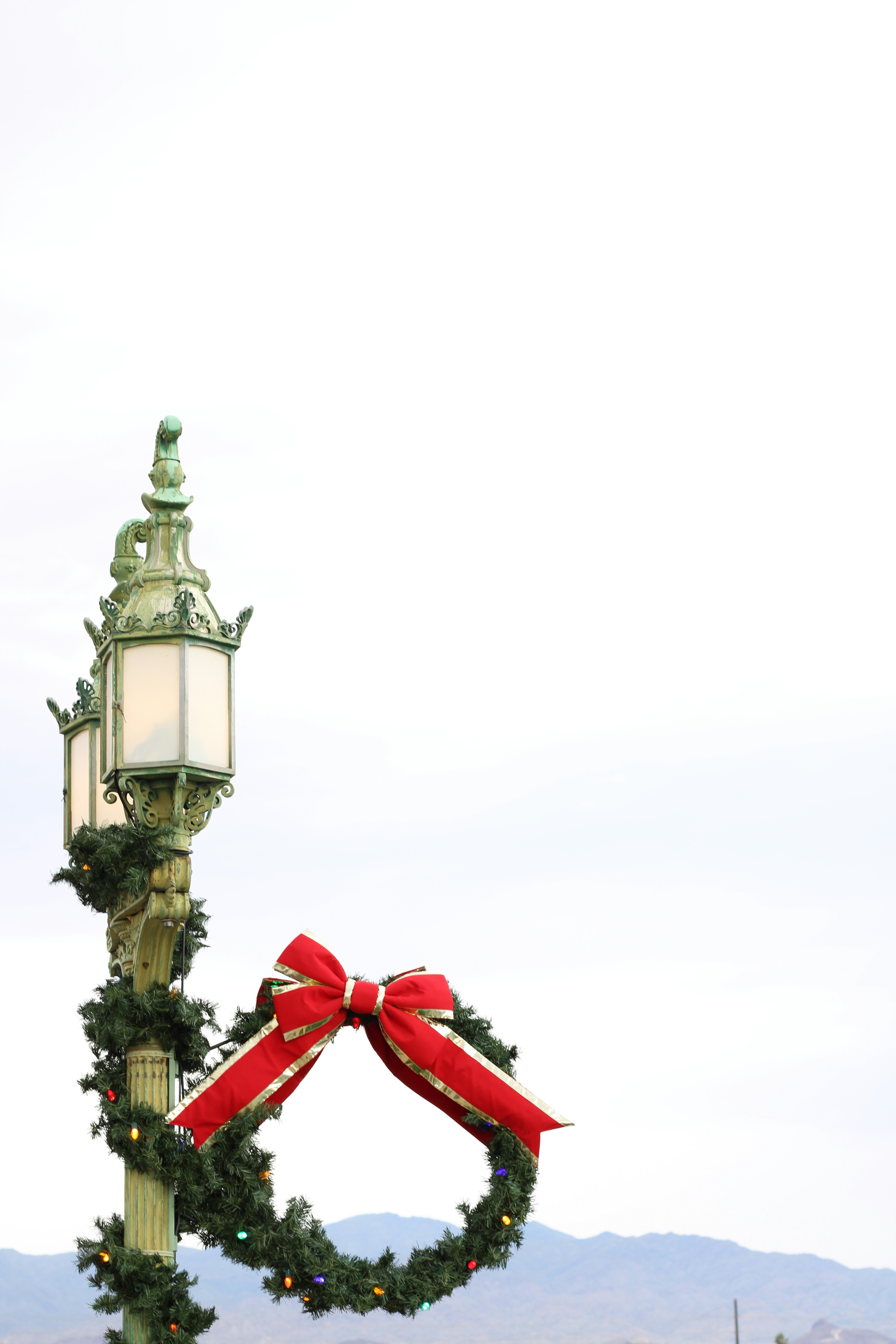 Street lamp decorated with christmas wreath and garland