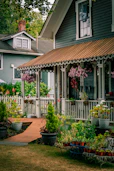 Charming house with a white picket fence and flowers.
