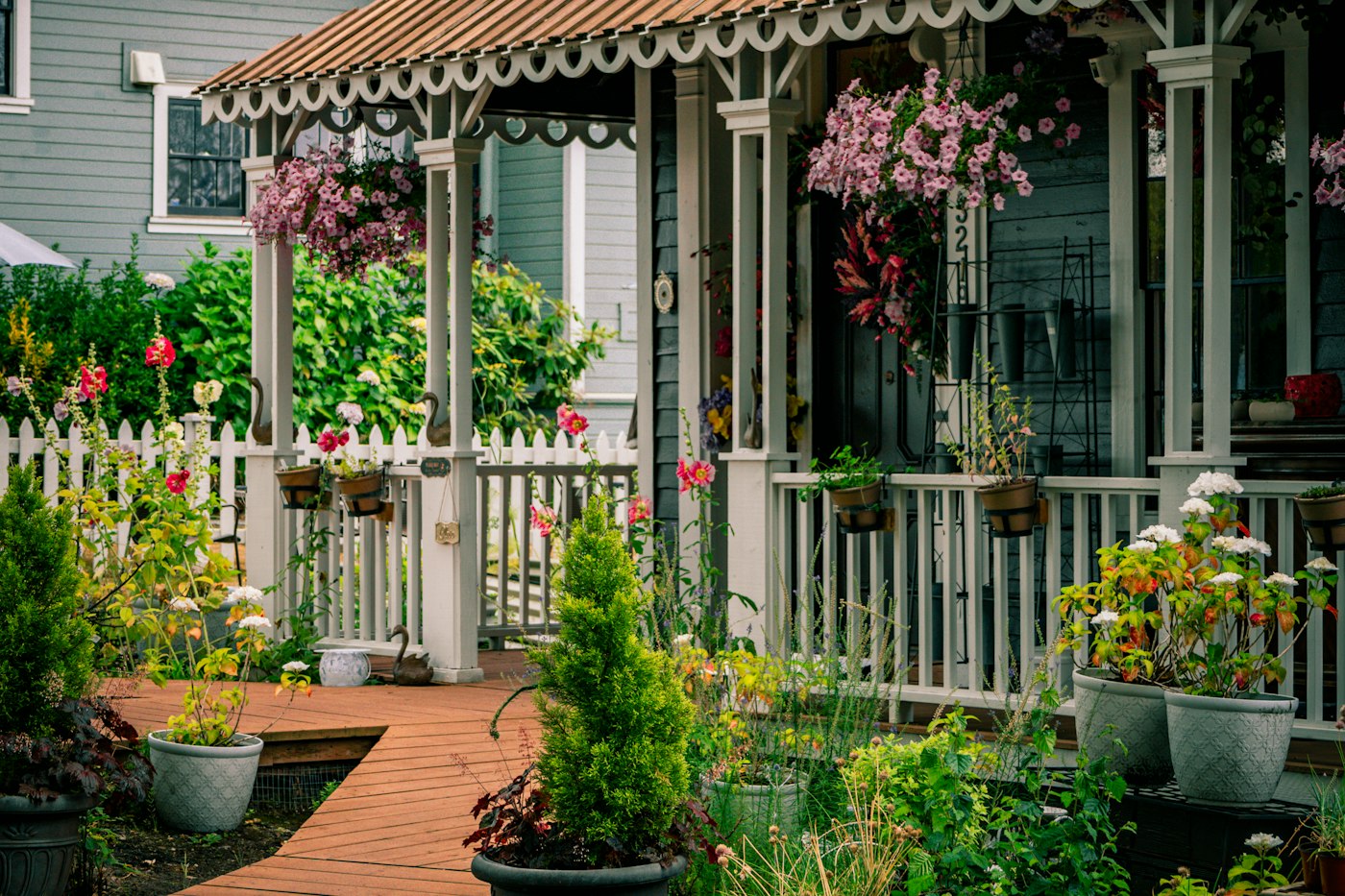 White picket fence with flowers, one of many front yard landscaping ideas