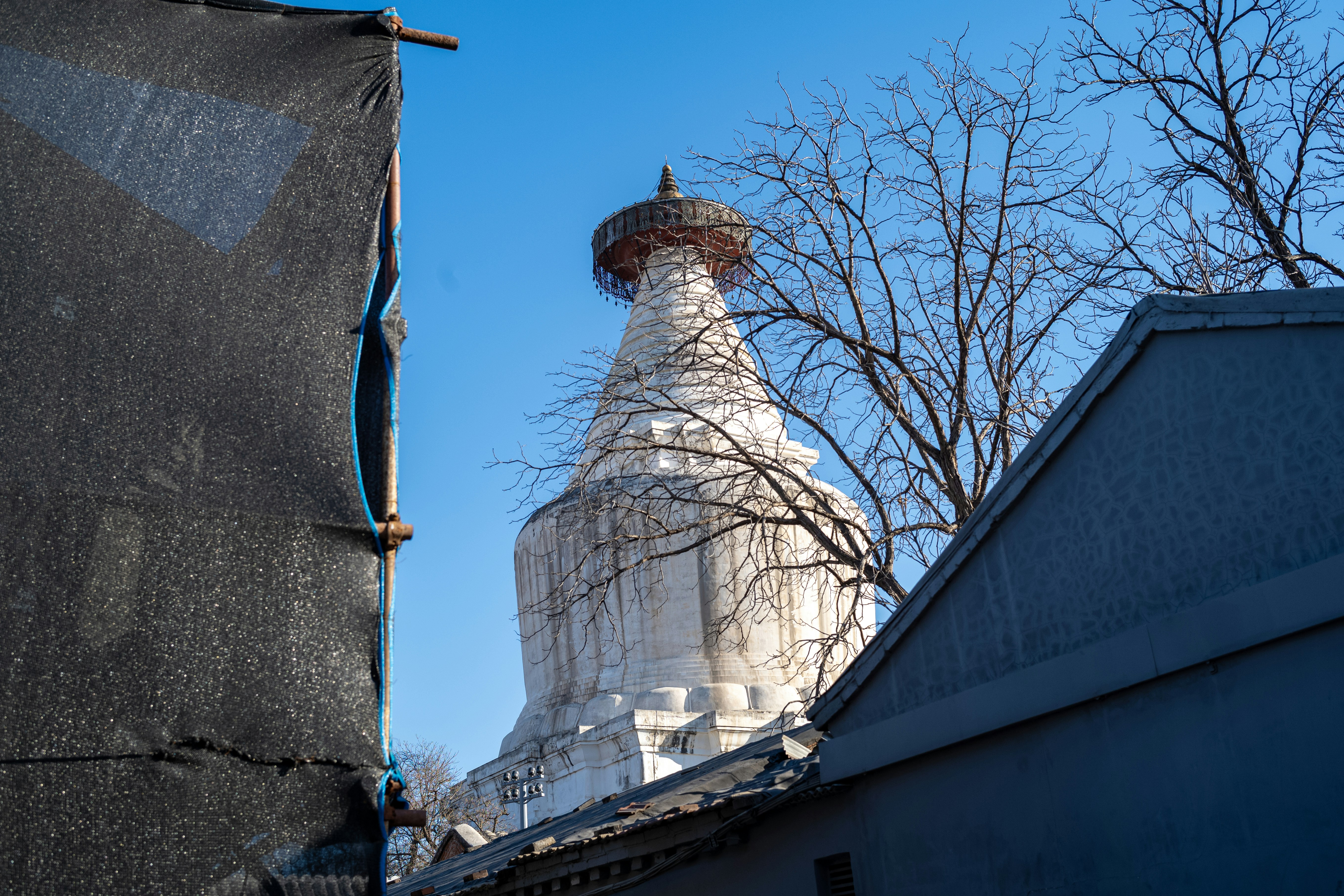 White stupa against a clear blue sky