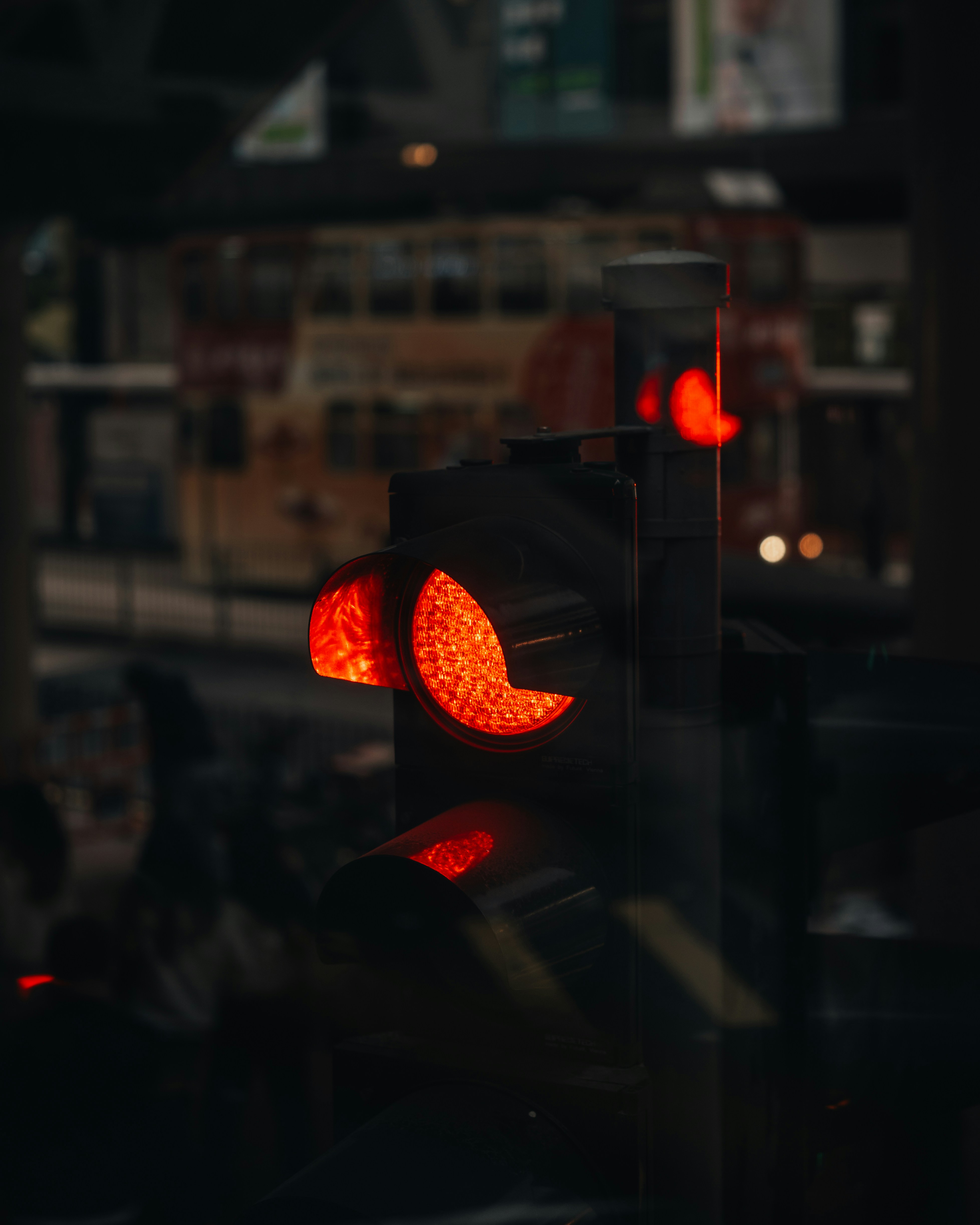 A red traffic light glows in the dark.