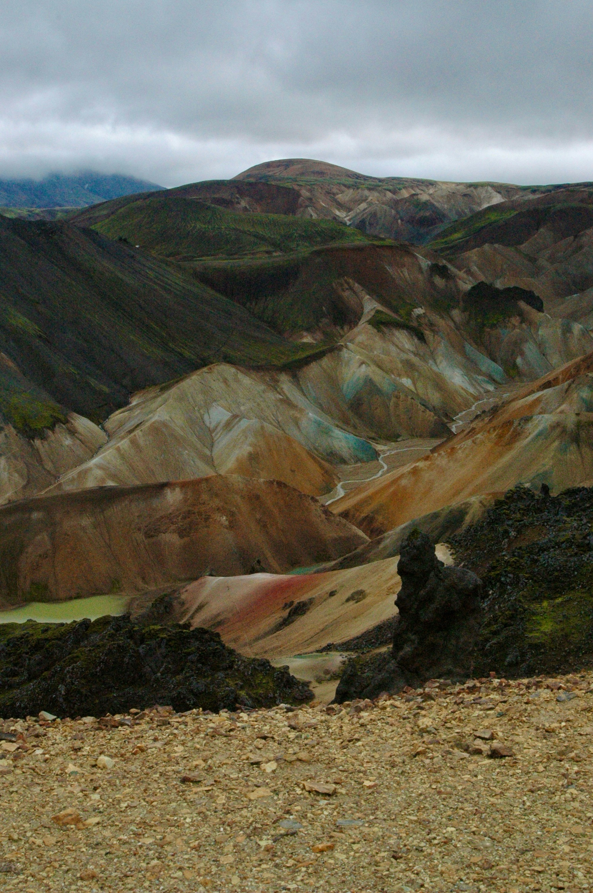 Colorful mountains and valleys under a cloudy sky