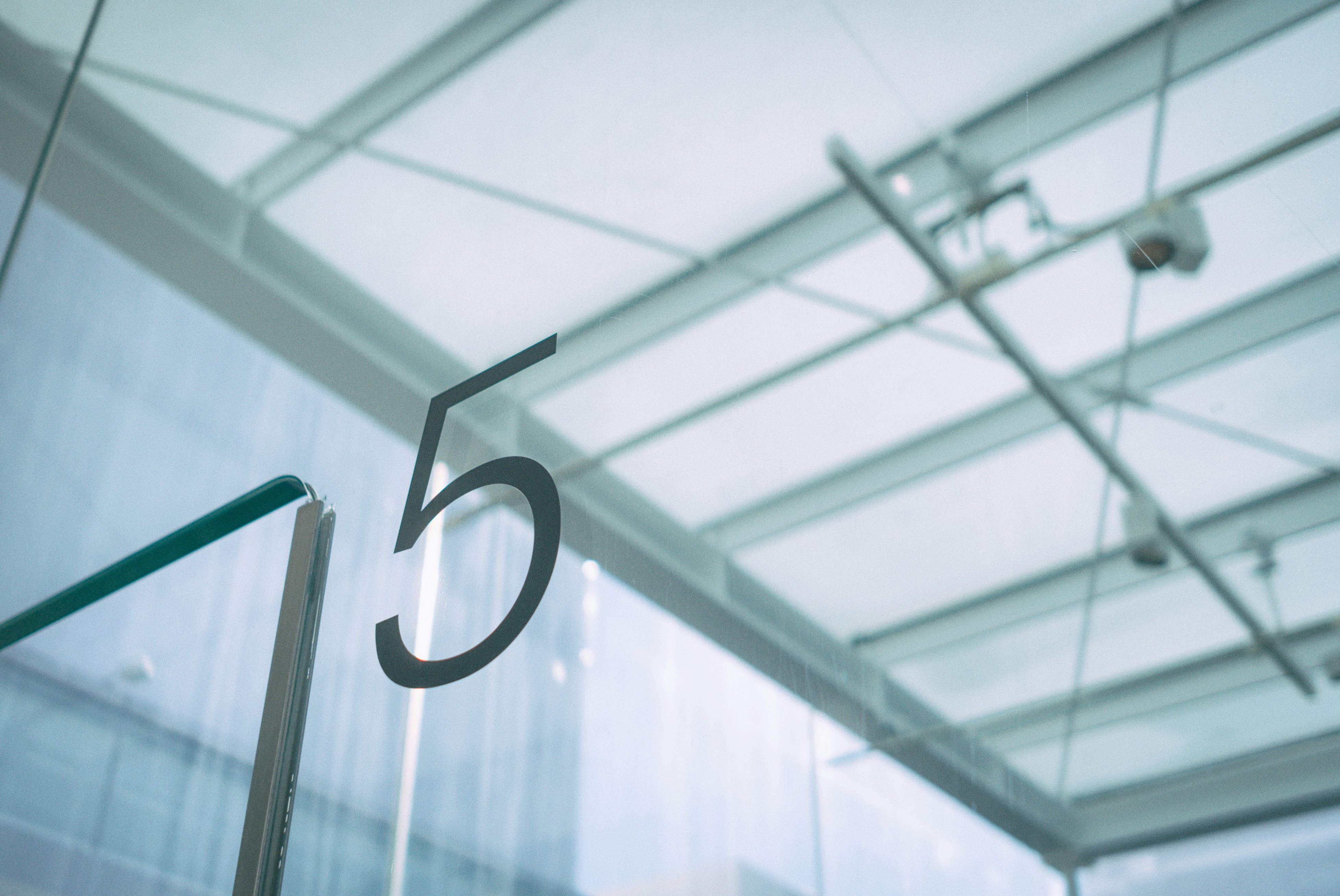 A large number 5 on a glass surface