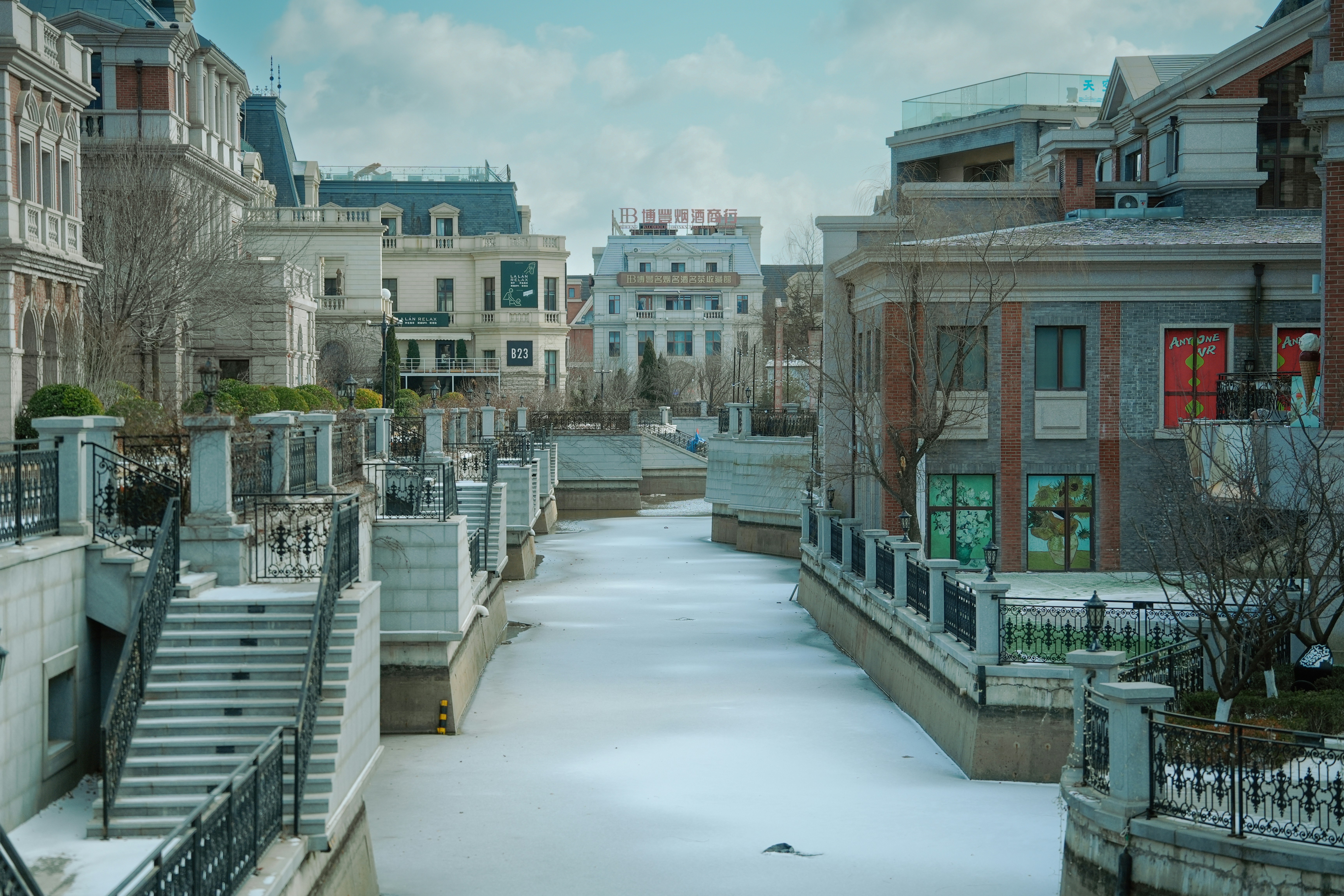 A frozen canal flows through a european-style town.