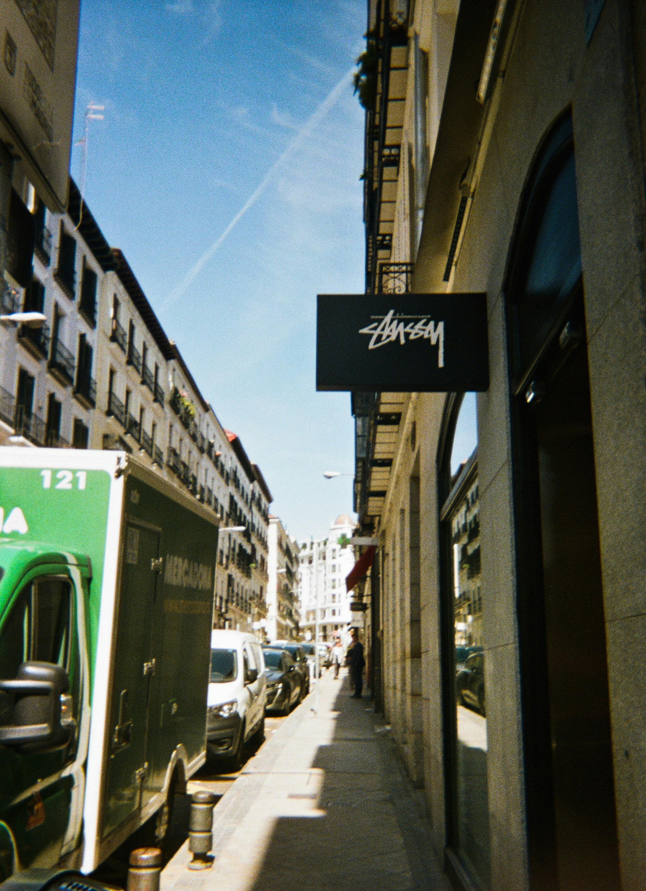 Street scene with stussy sign and delivery truck