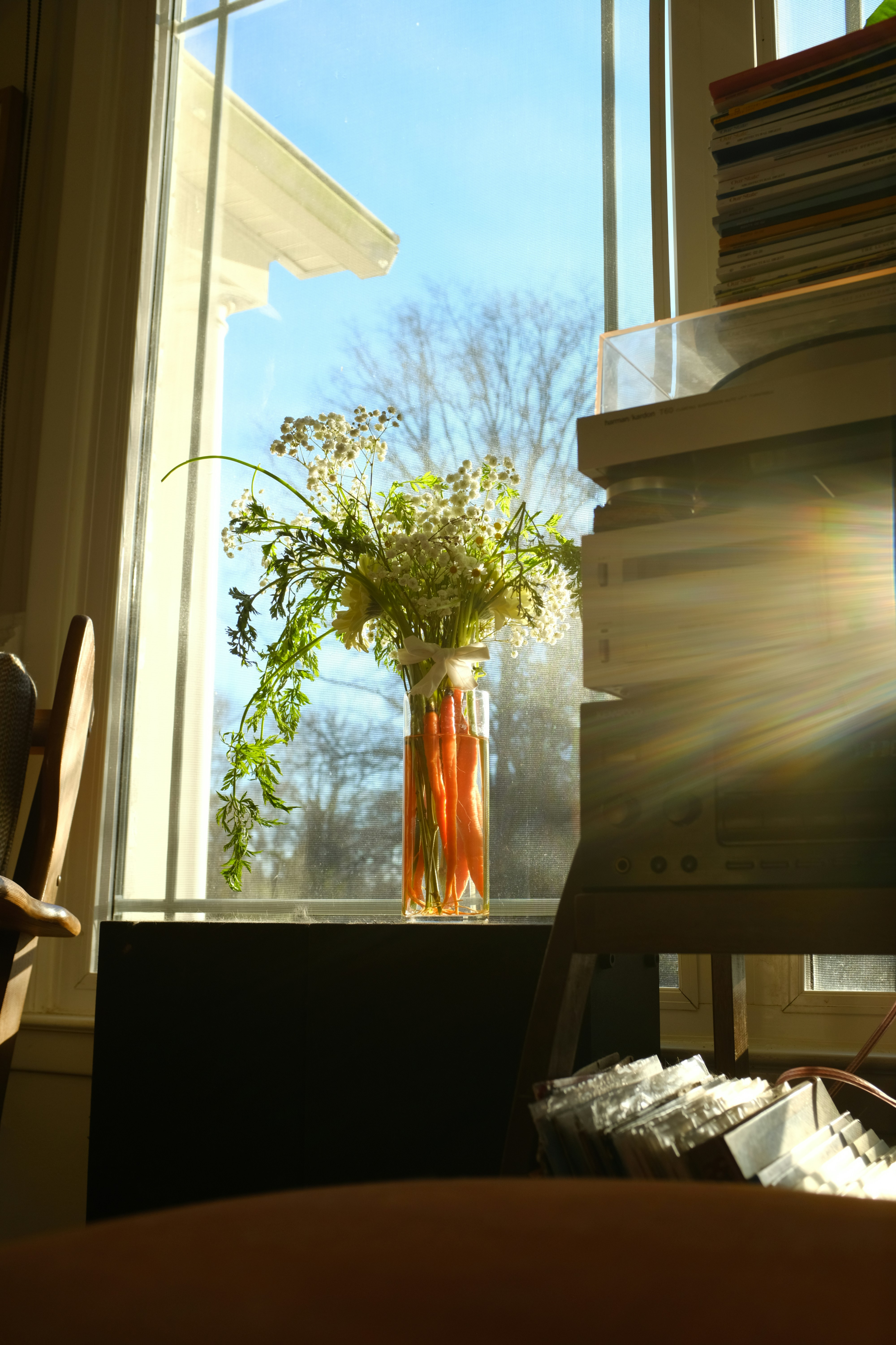 Vase of wildflowers on a sunny windowsill