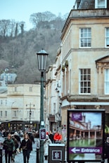 People walking down a street with historic buildings.