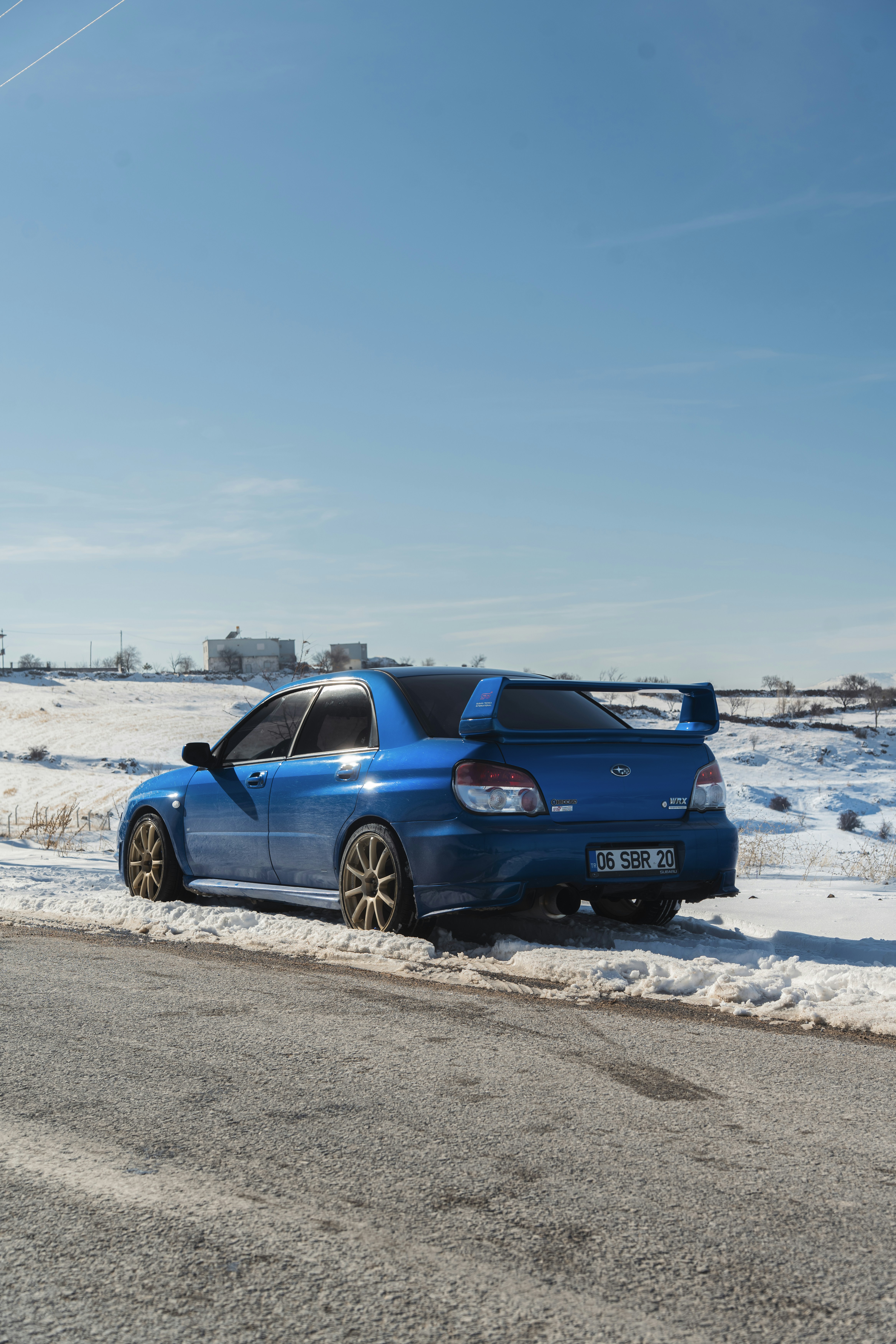 Blue subaru wrx sti parked on snowy road