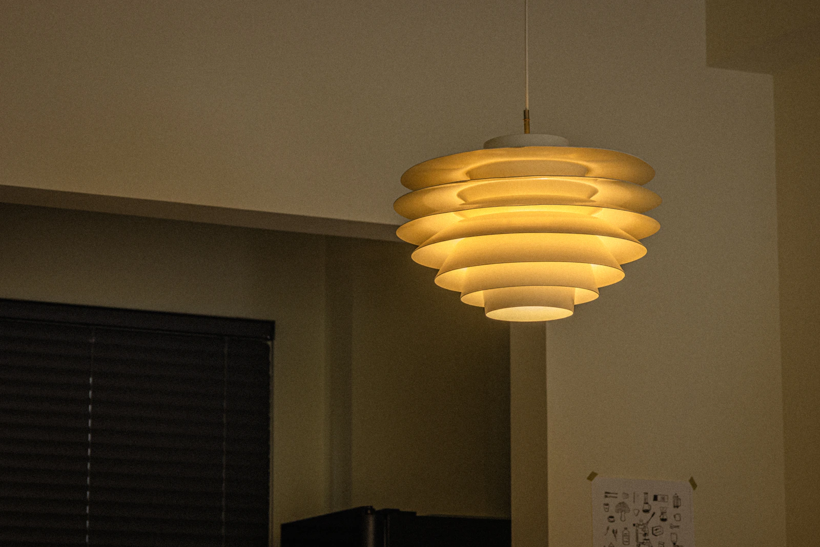 Contemporary pendant light casting a warm architectural glow in a refined interior