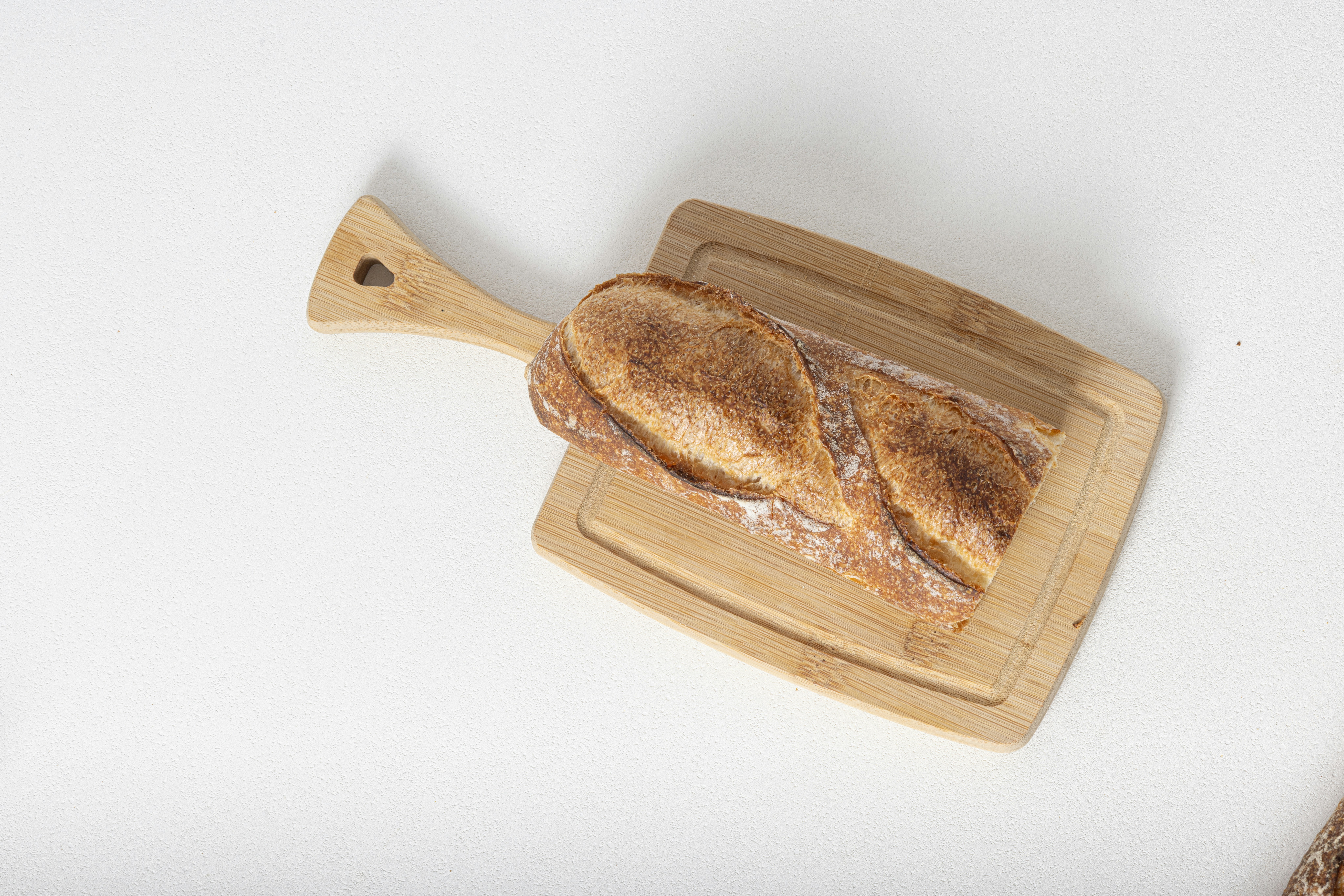 A crusty baguette on a wooden cutting board