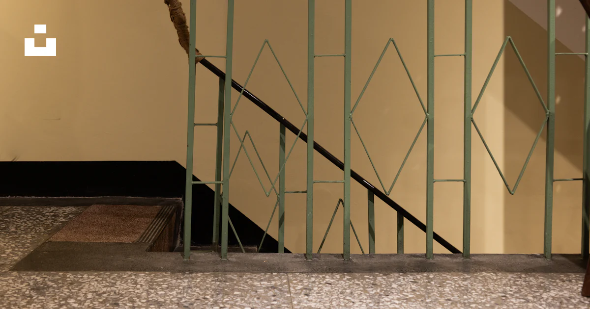 A staircase with a green metal railing photo – Free Architecture Image ...