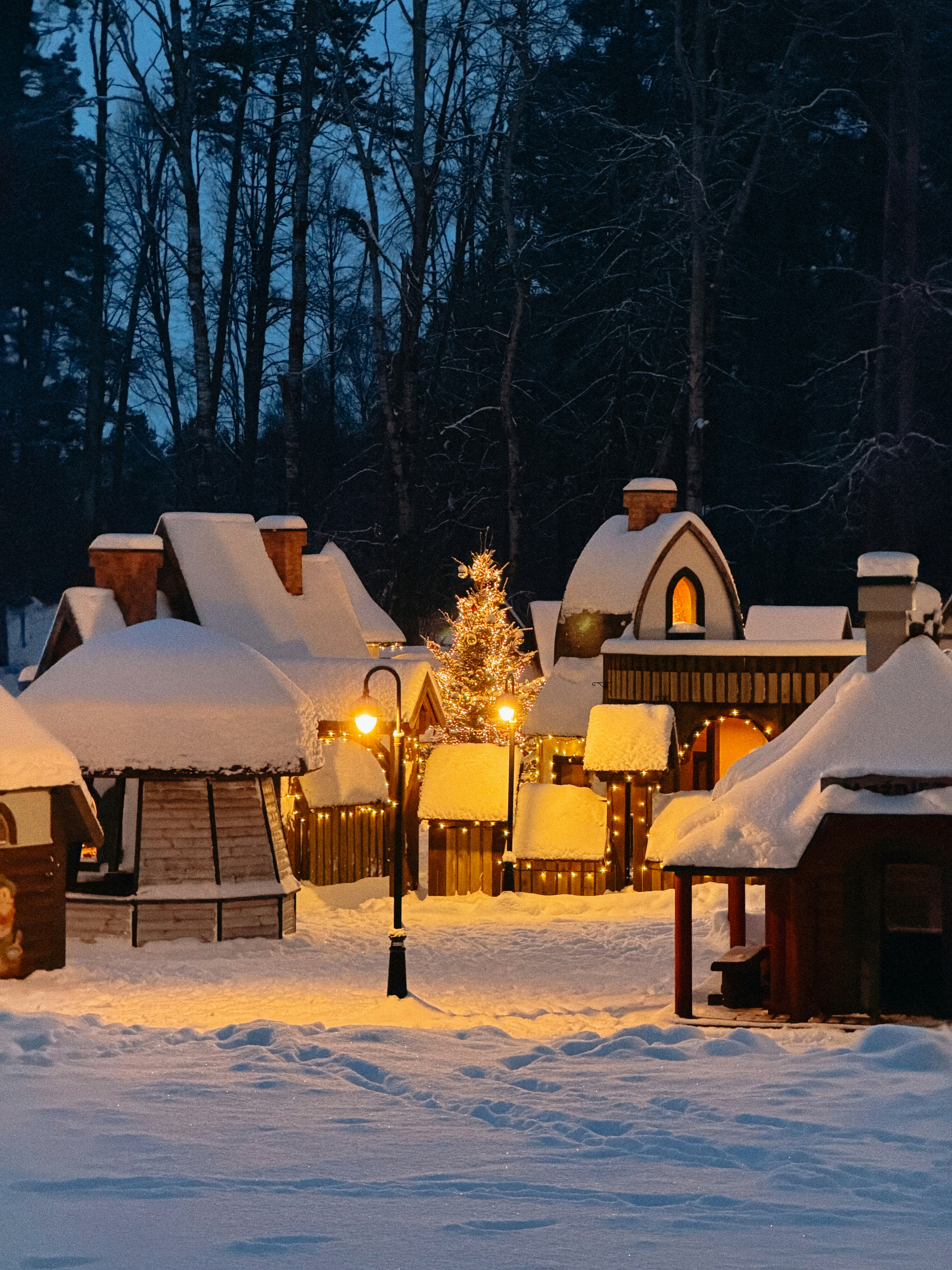 Snow-covered village with festive christmas lights