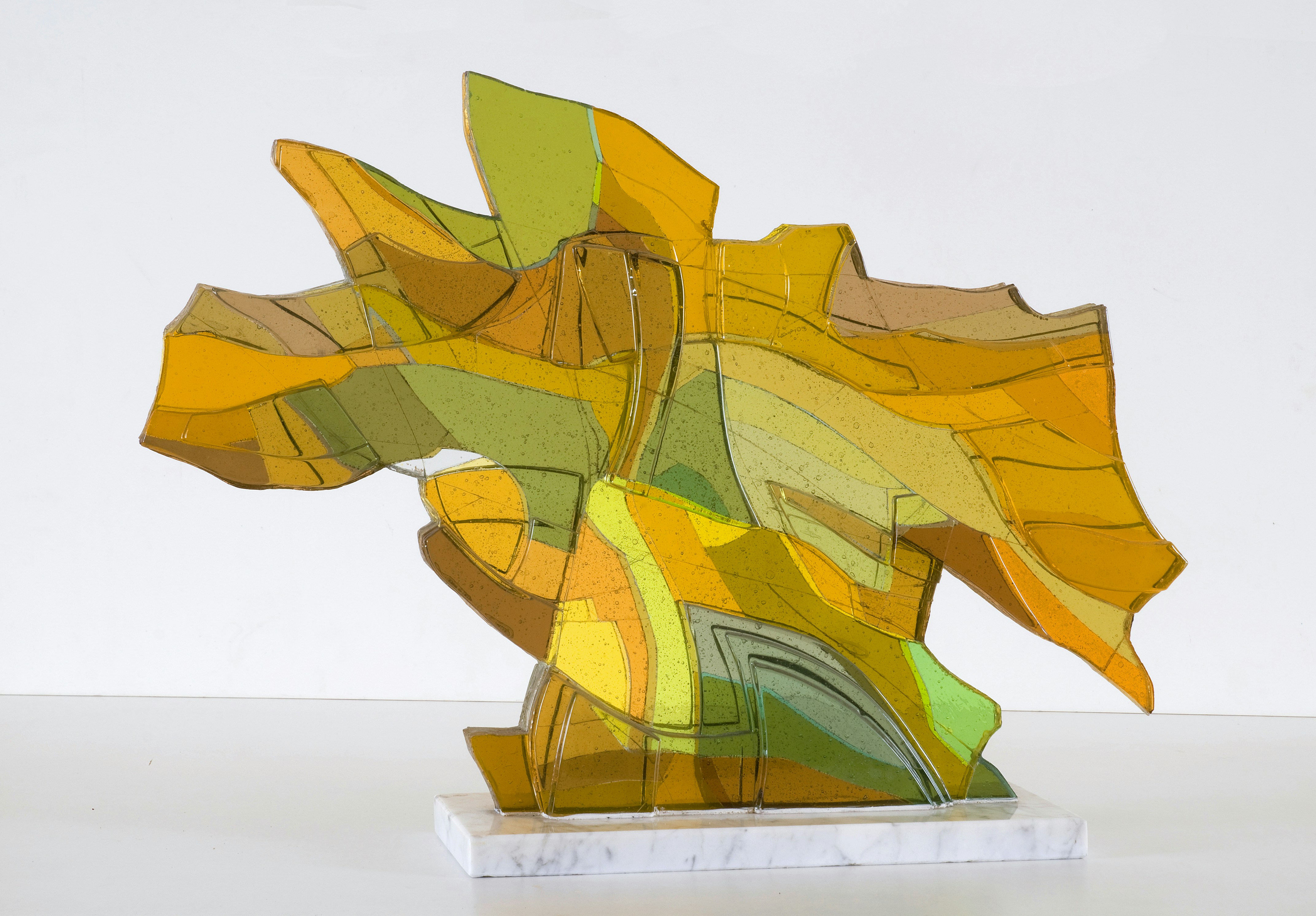 Abstract sculpture with yellow, green, and orange hues.