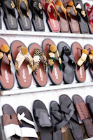 Rows of decorative sandals displayed on shelves