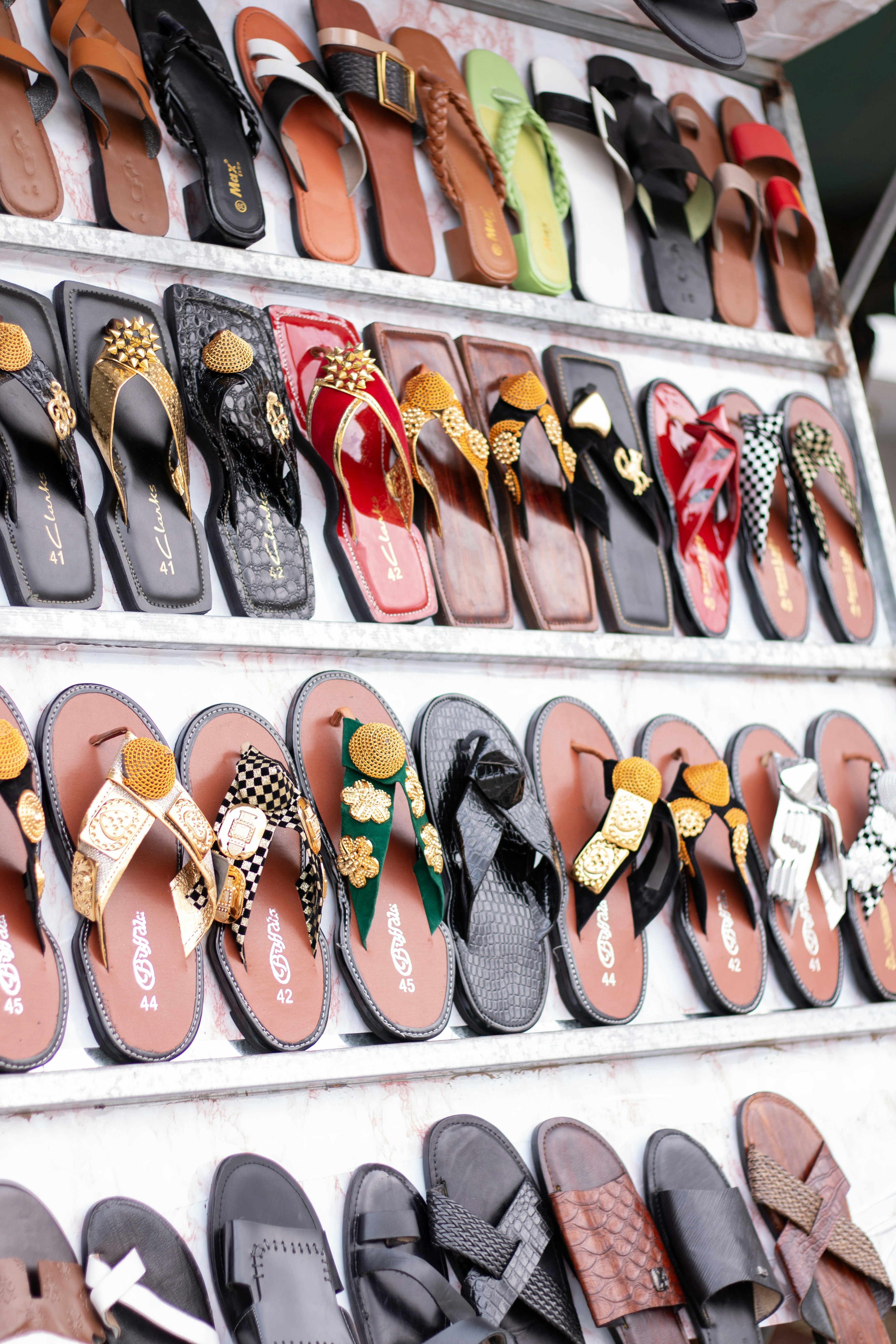 Display of various colorful sandals and flip-flops