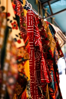 Colorful textiles with intricate patterns hanging on display.
