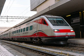 A modern red and white train at a station