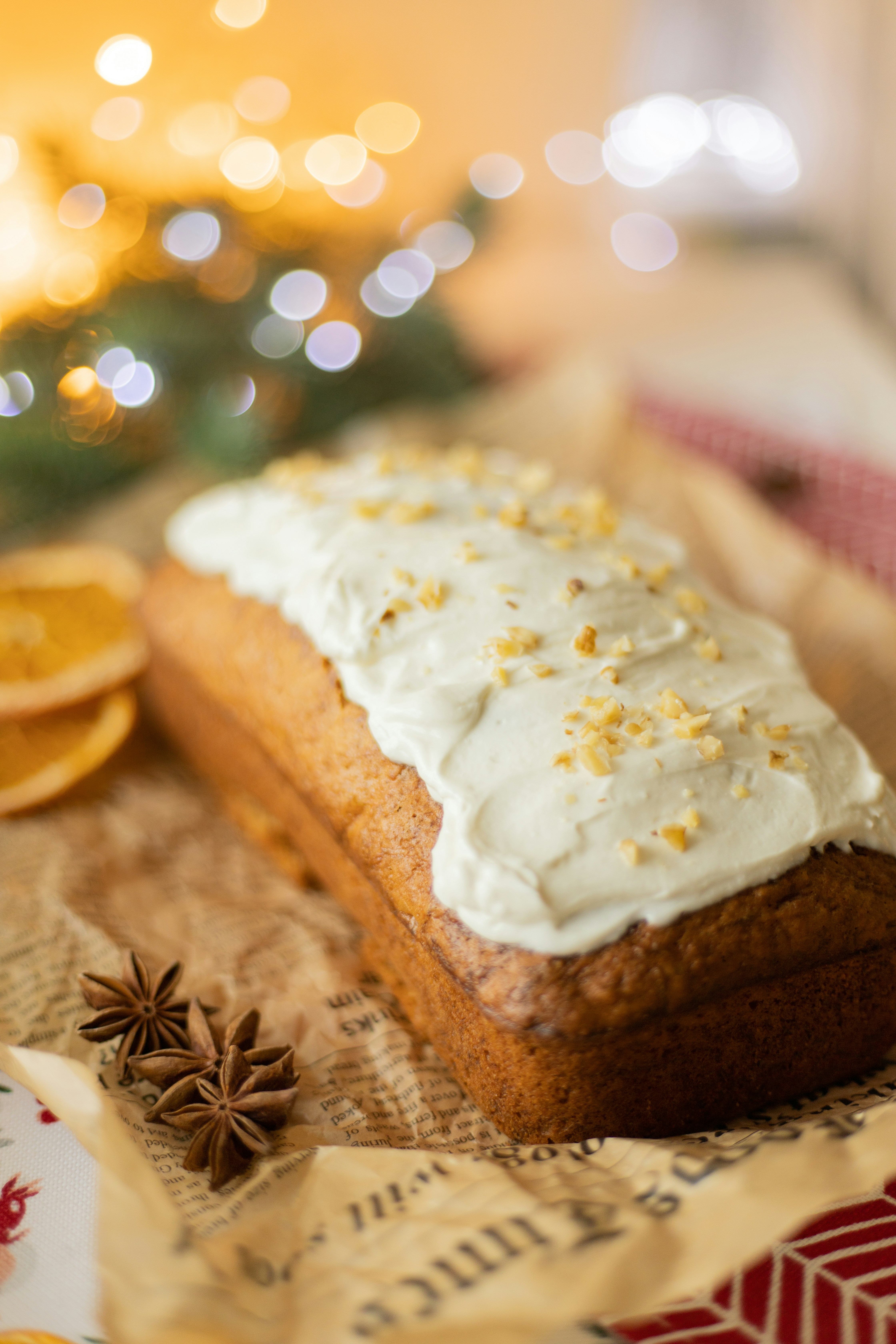 Frosted loaf cake with nuts and star anise