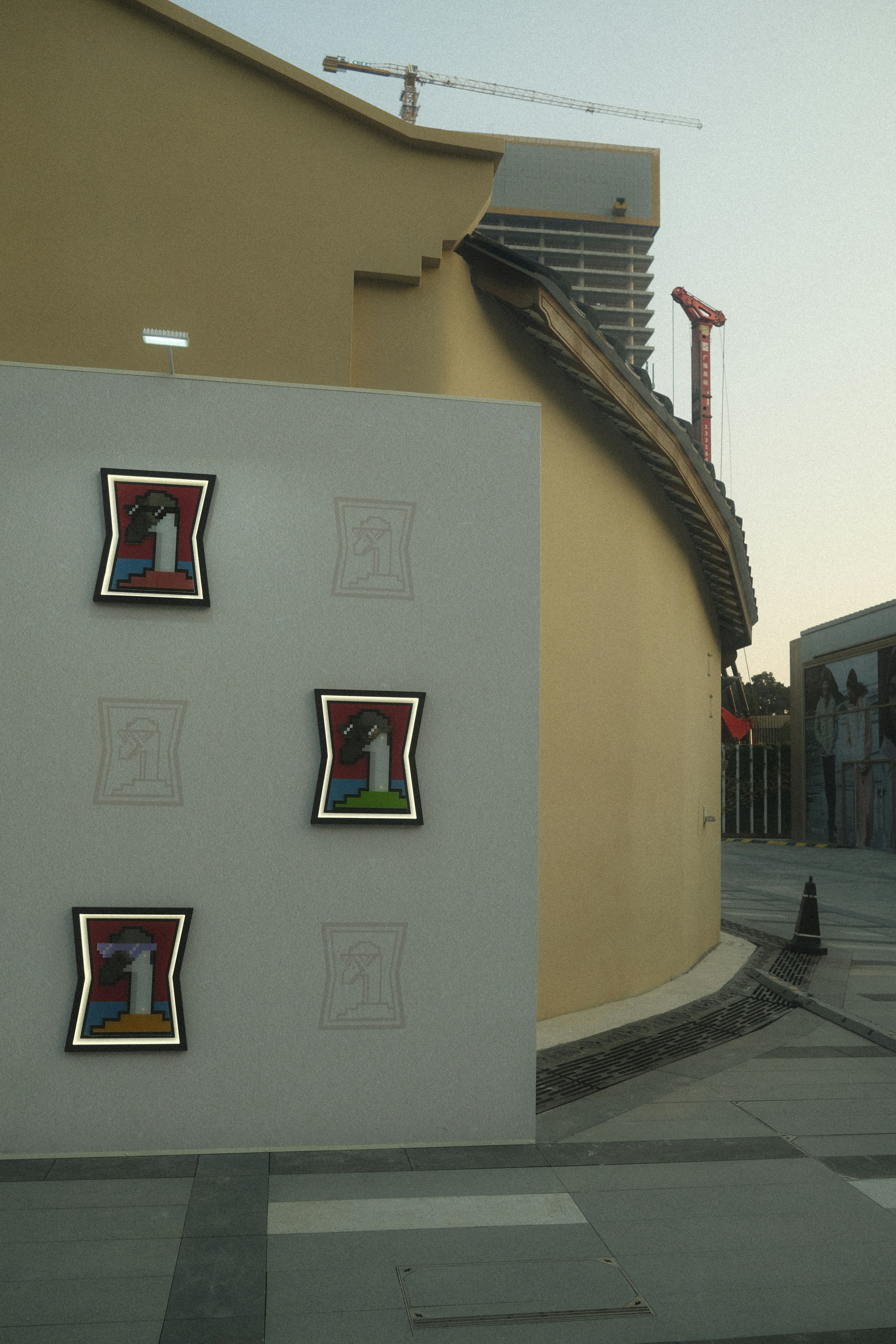 Three framed artworks displayed on a wall.