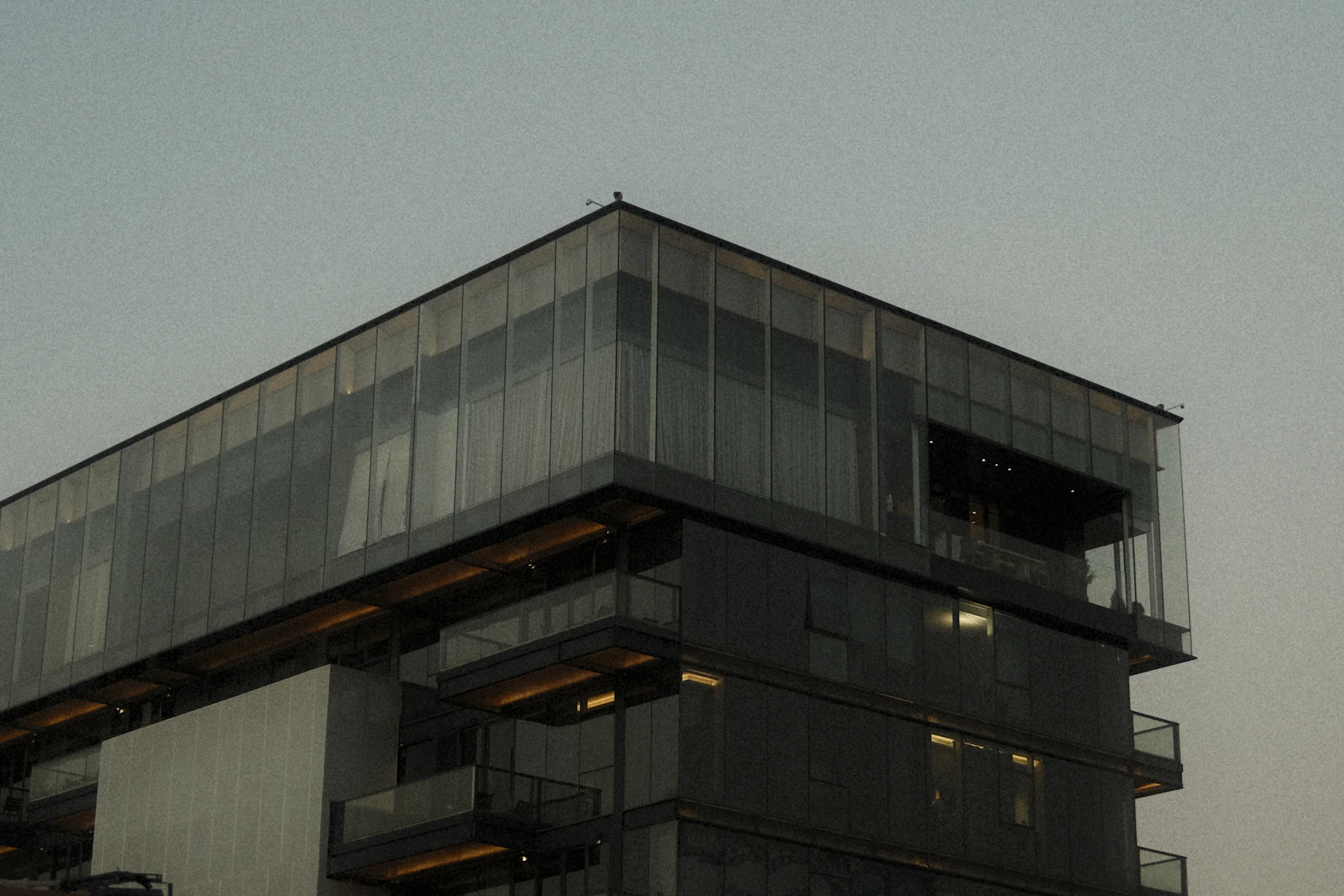 Modern building with glass facade against sky