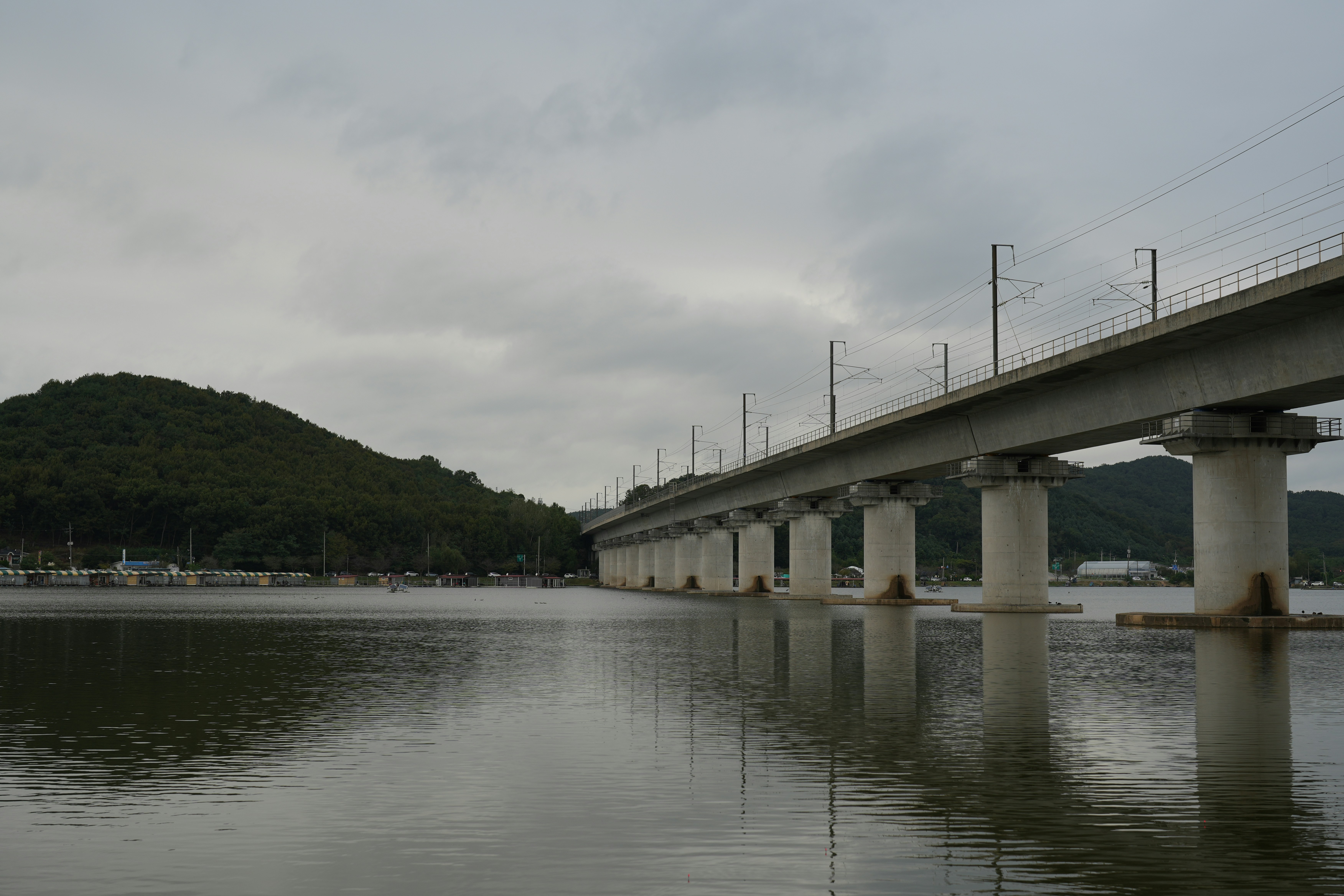 A long concrete bridge over calm water