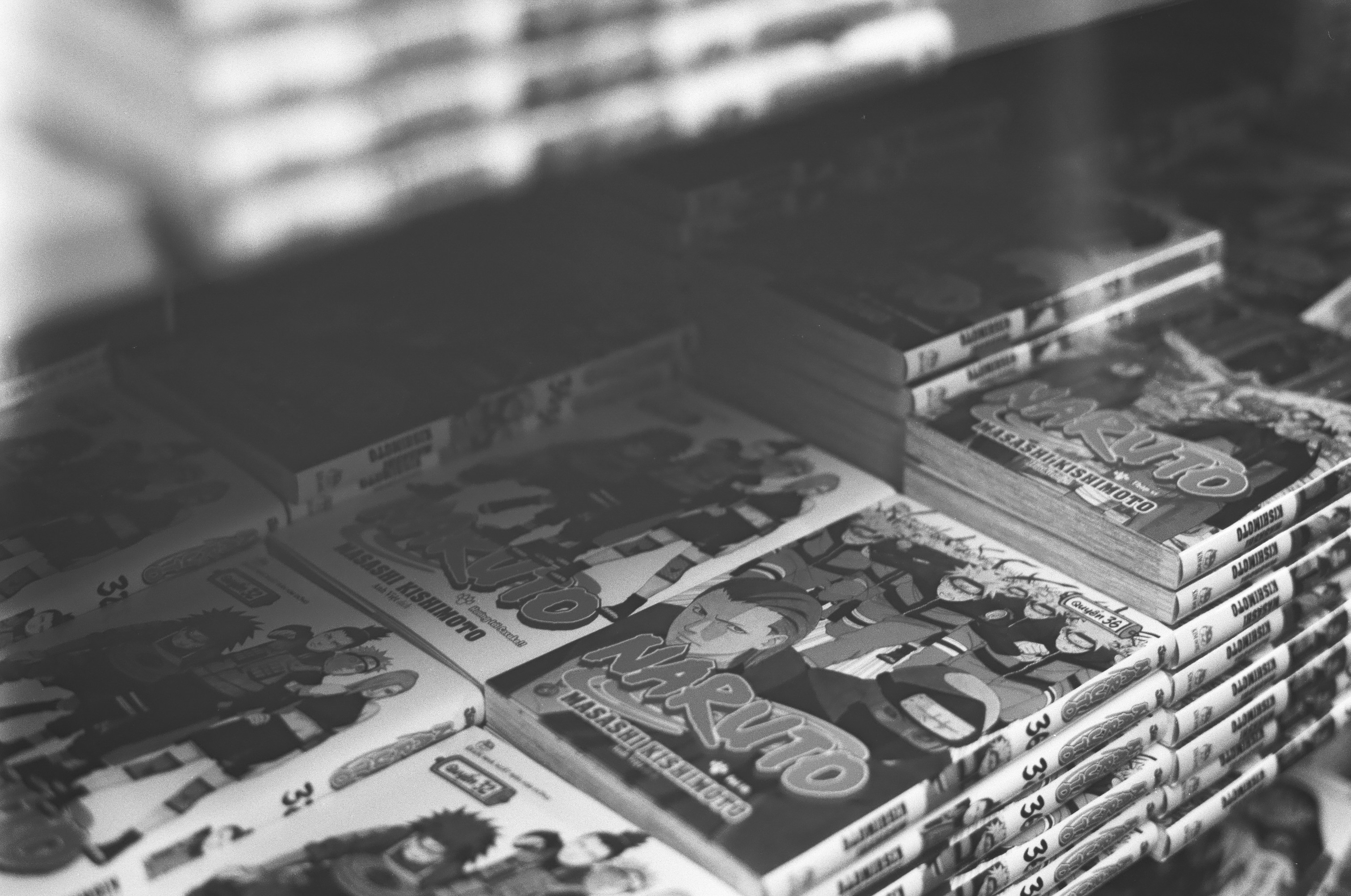 Stacks of manga books on a shelf