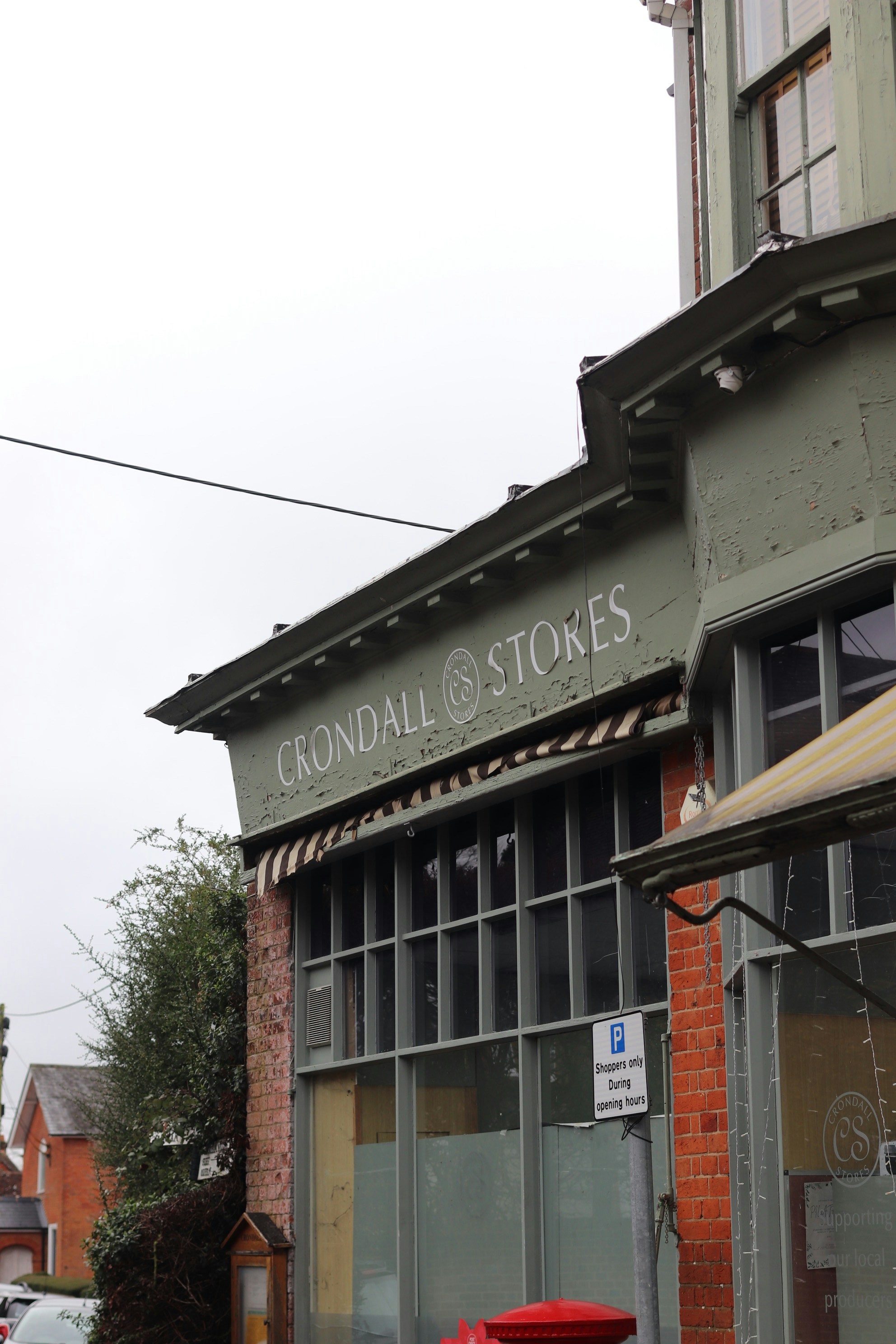 Crondall stores building exterior with red post box.