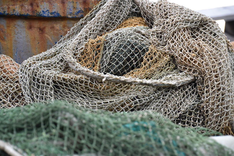Pile of fishing nets with rusty background