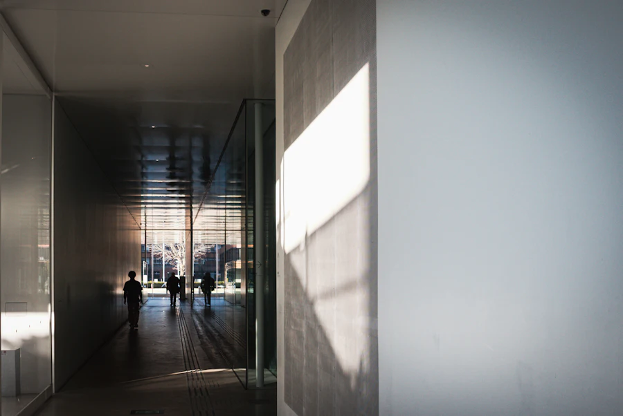 People walking through a sunlit modern passage