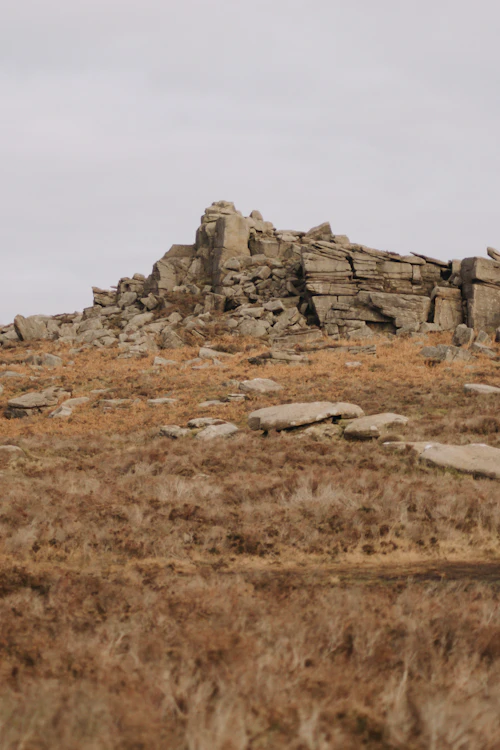 Rocky gritstone outcrop on a hillside at Millstone Edge in the Peak District, just outside Sheffield