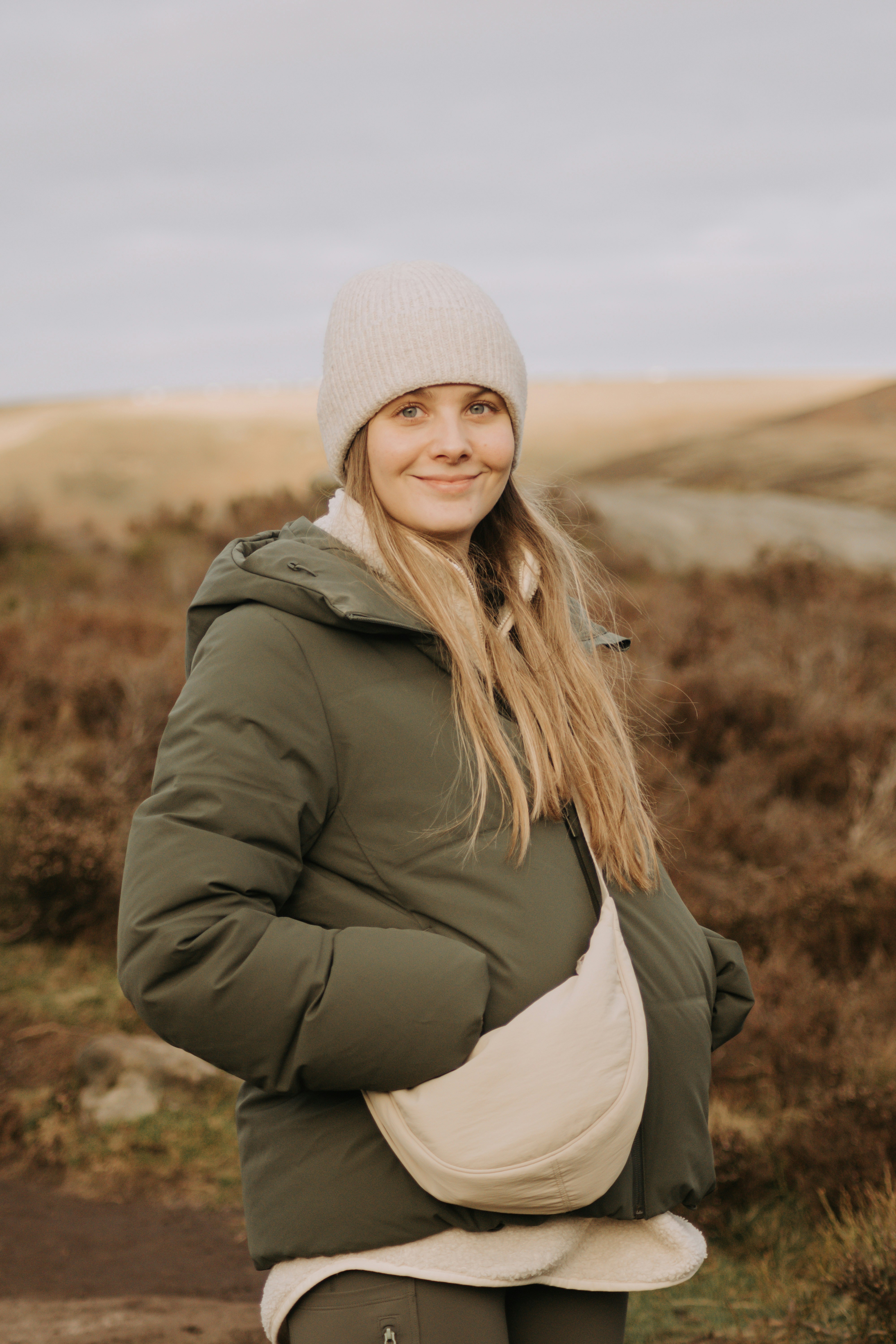 Young woman in a puffer jacket and beanie outdoors