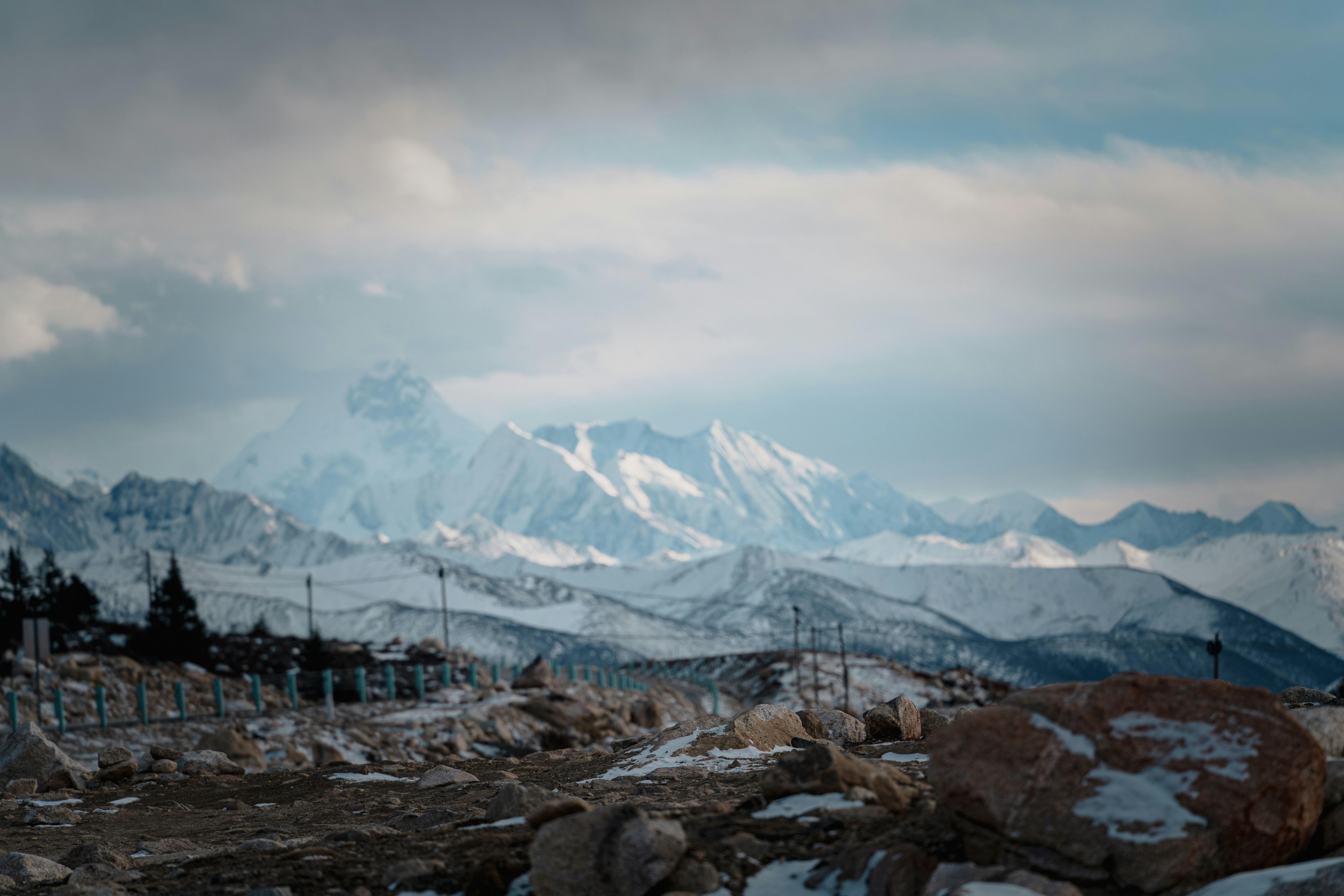 Snow-covered mountains under a cloudy sky
