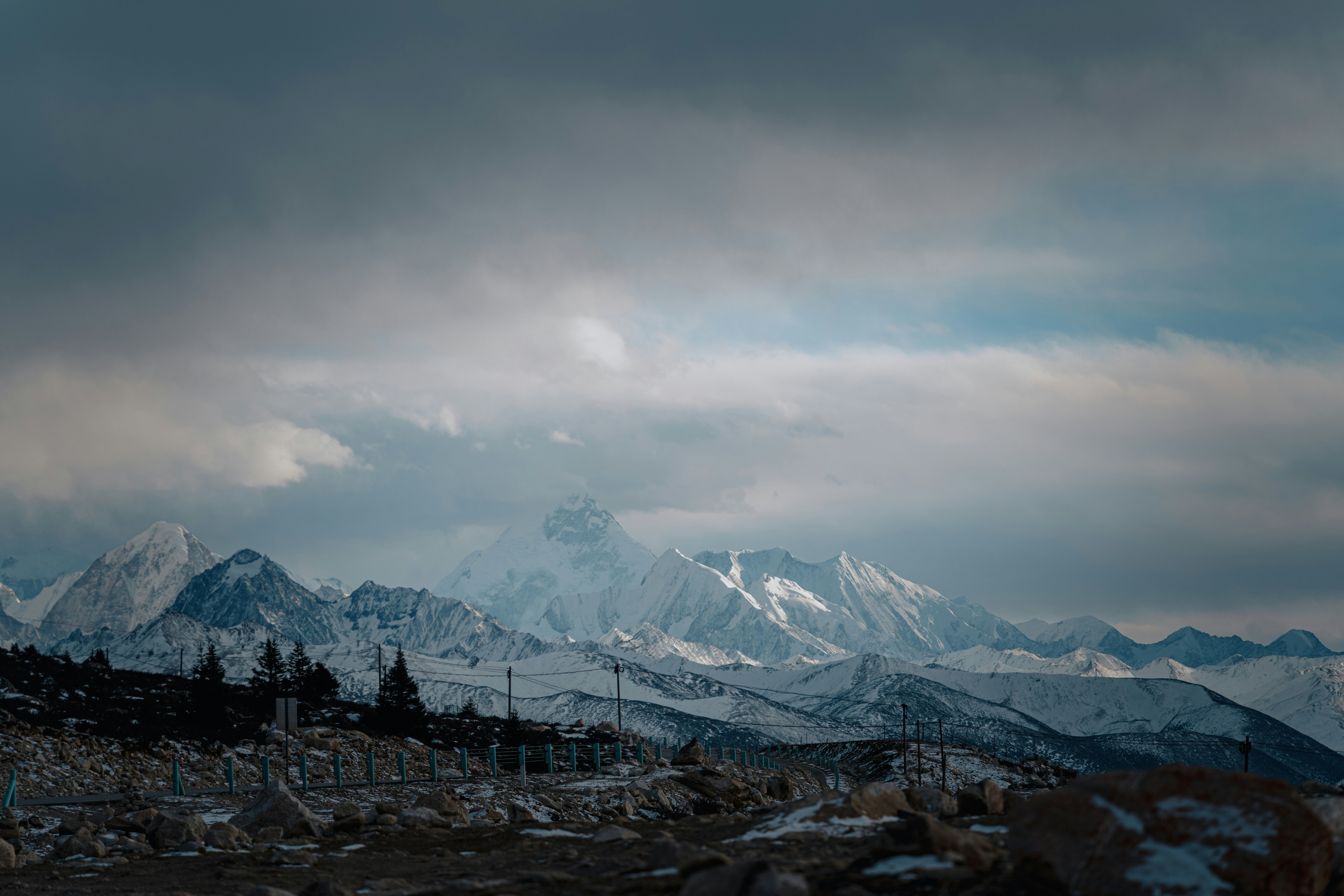 Snow-covered mountains under a cloudy sky