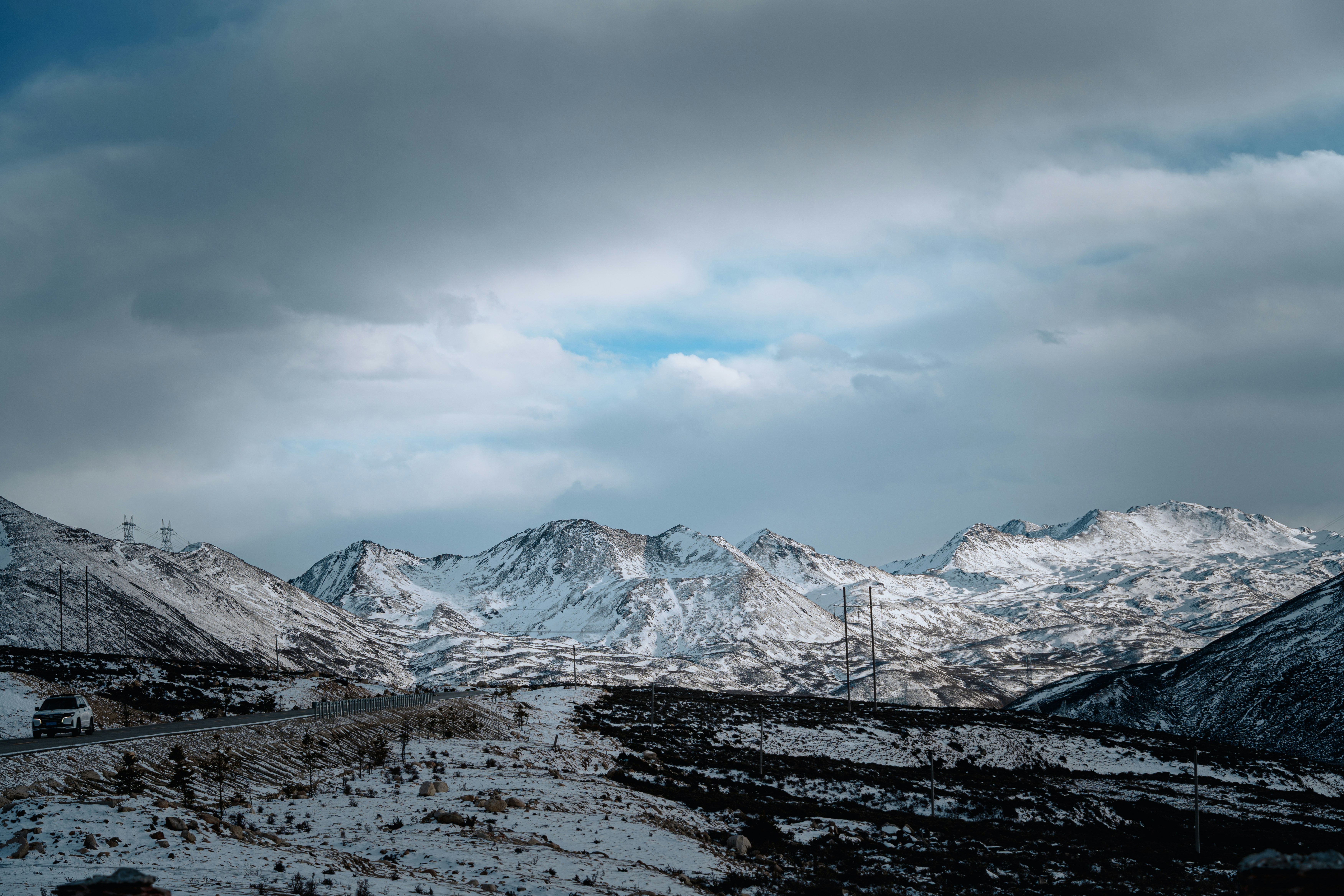 Snow-covered mountains under a cloudy sky