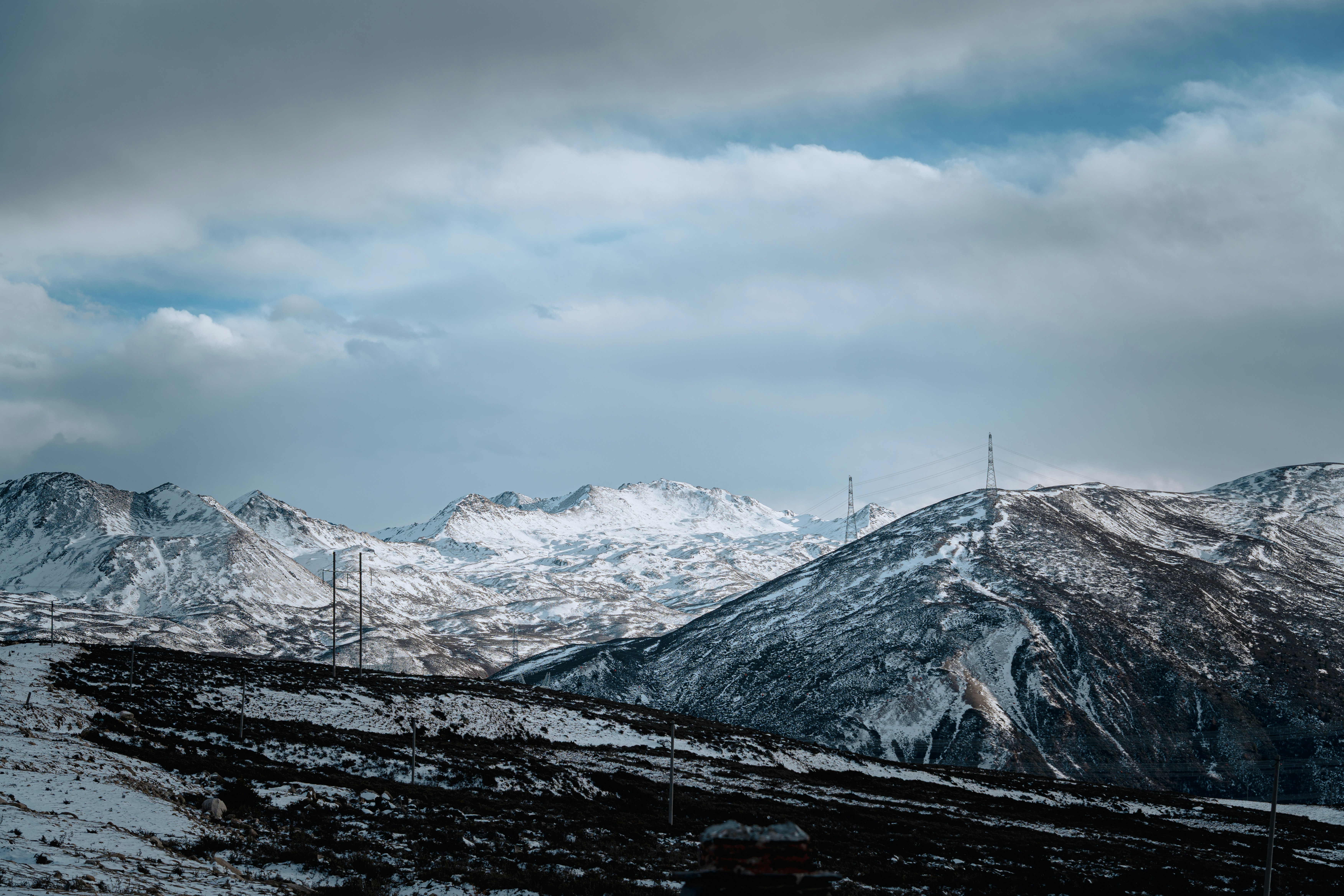 Snow-covered mountains under a cloudy sky
