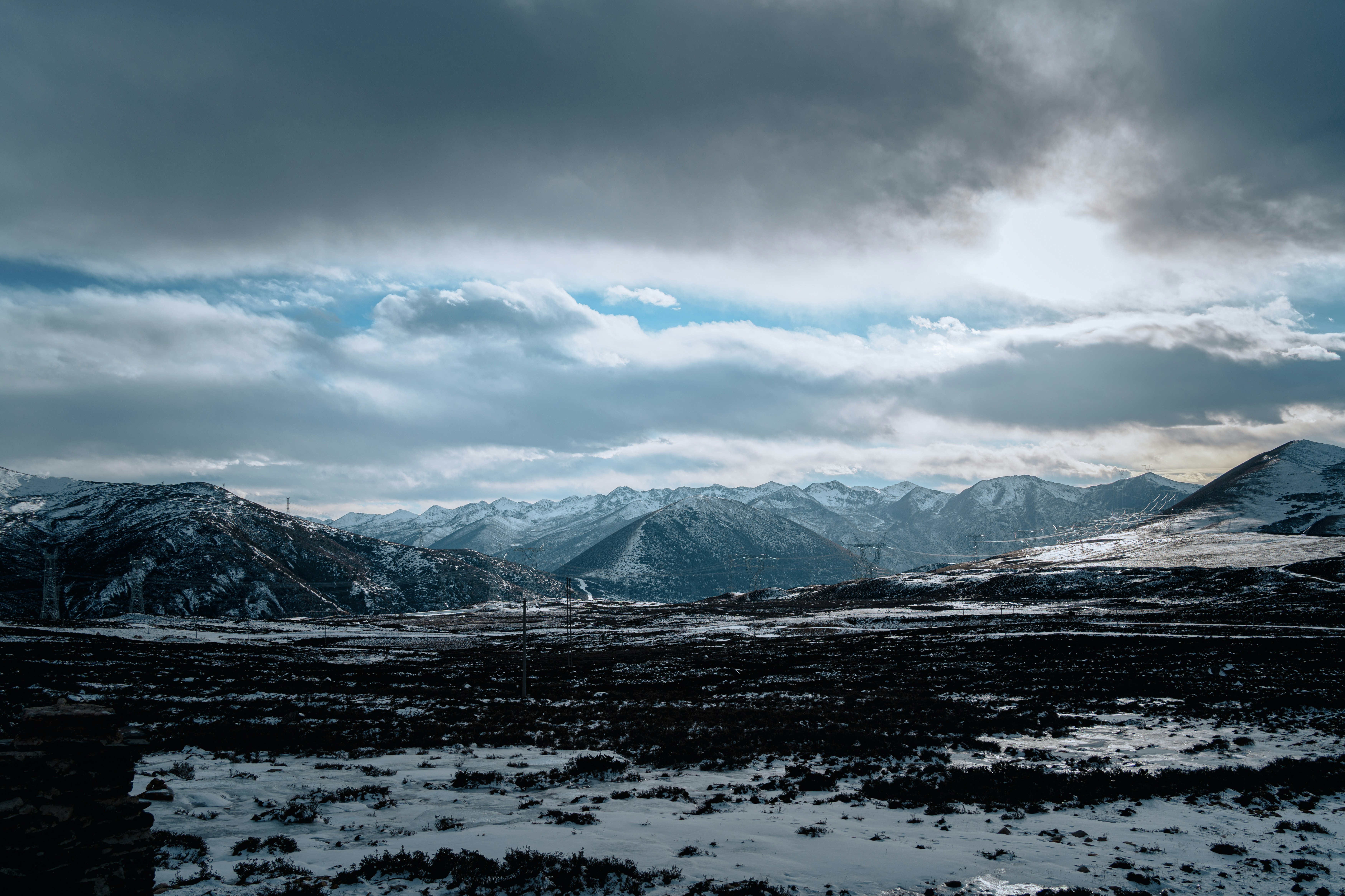 Snowy mountains under a cloudy sky