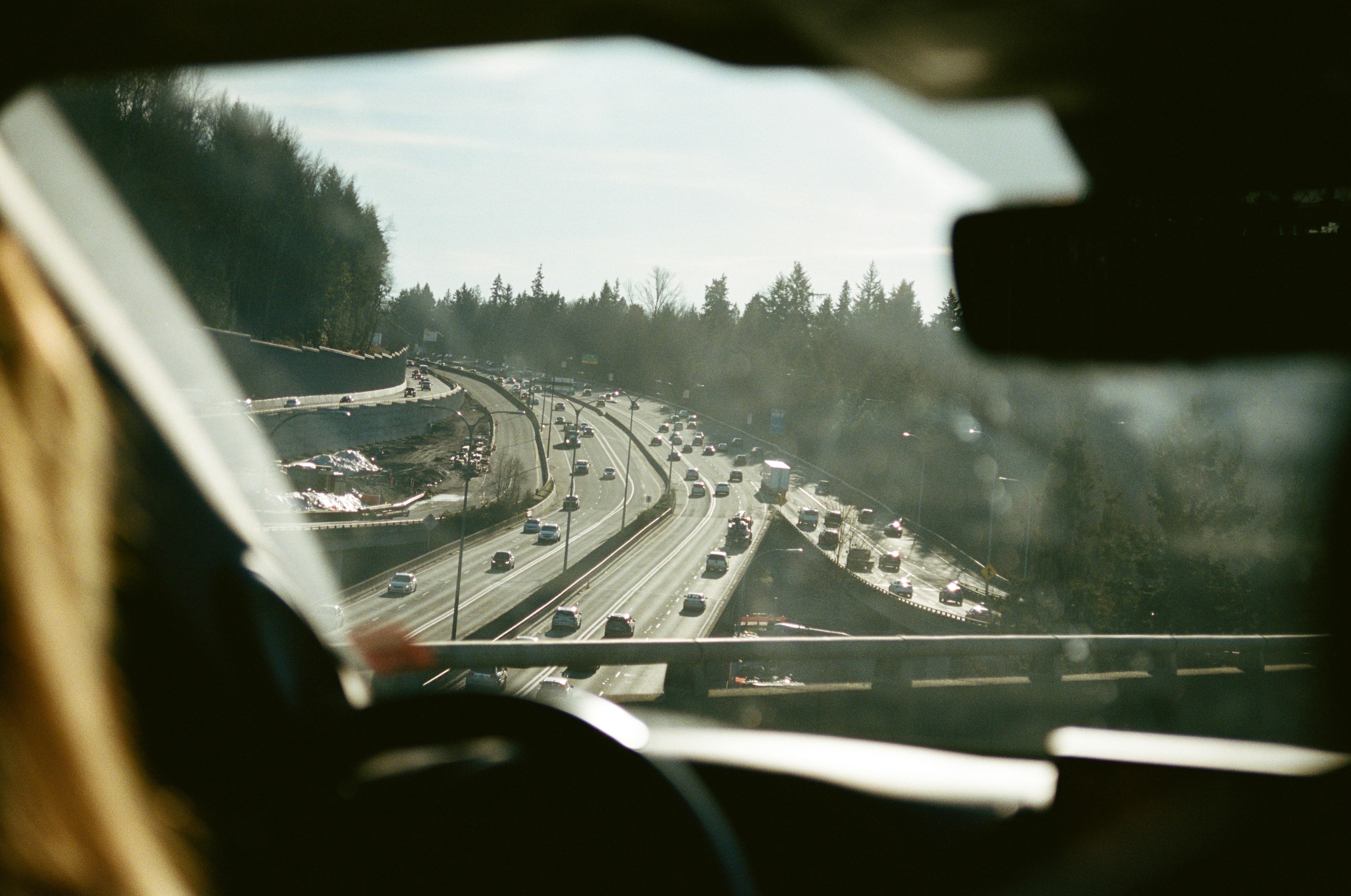 Cars driving on a busy highway through trees