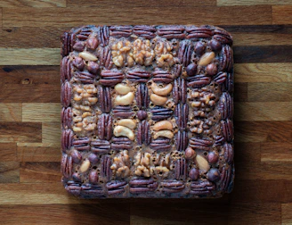 Square nut cake with woven pecan and walnut topping