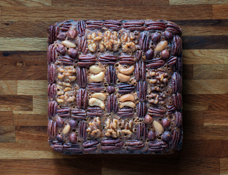 Square nut cake with woven pecan and walnut topping