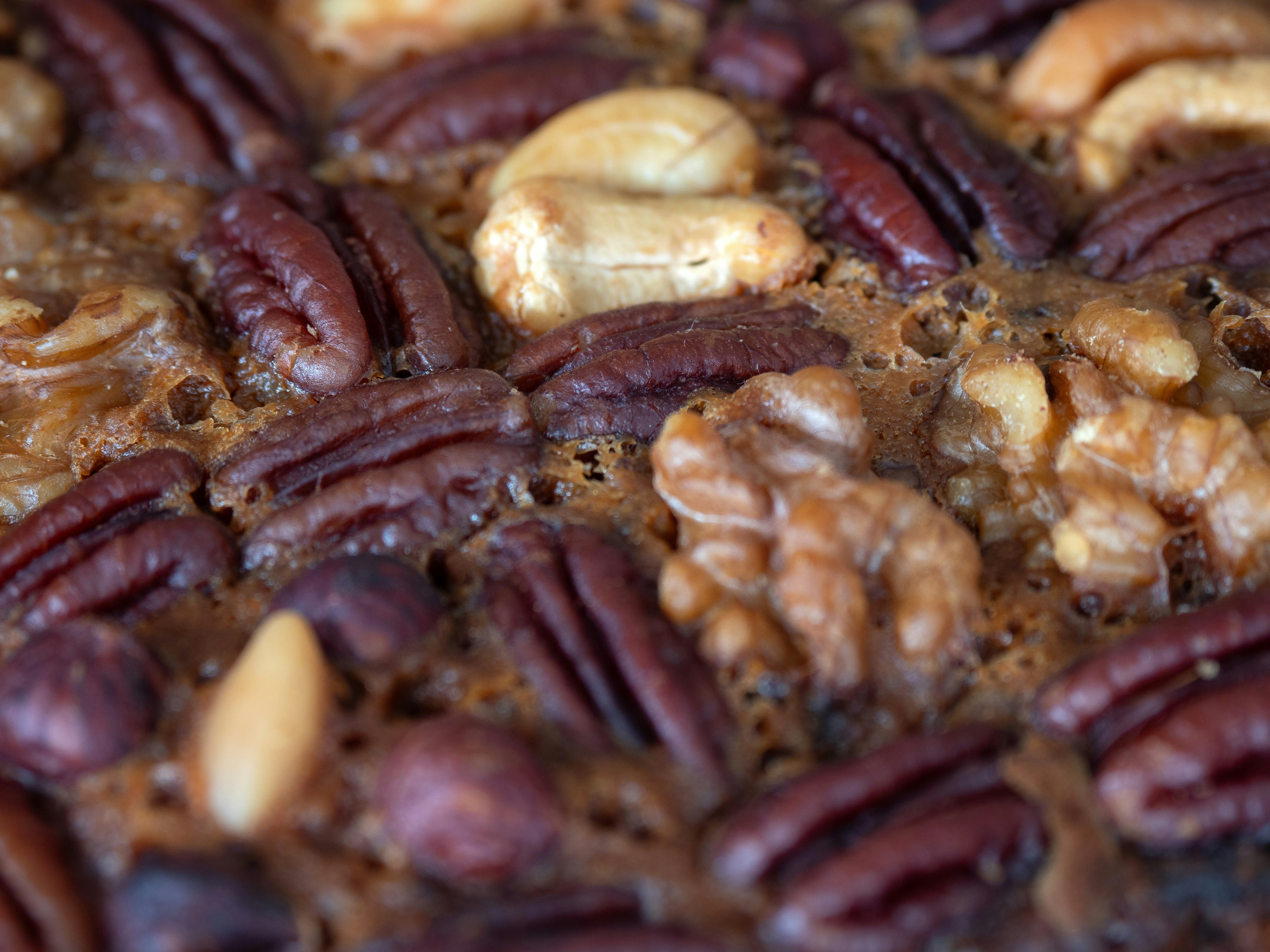 Assortment of nuts including pecans, cashews, and walnuts.
