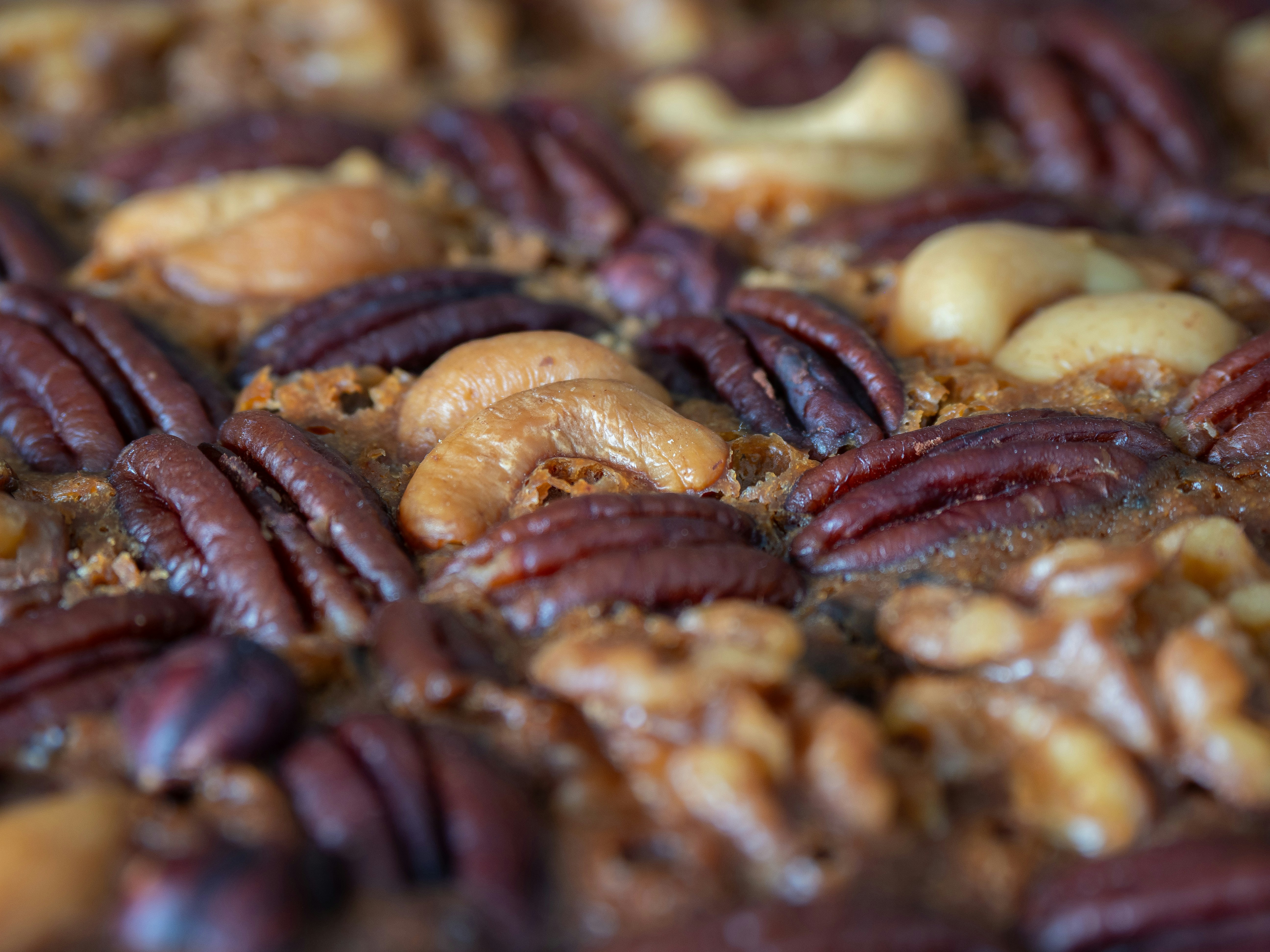 Close-up of mixed nuts including pecans and cashews.