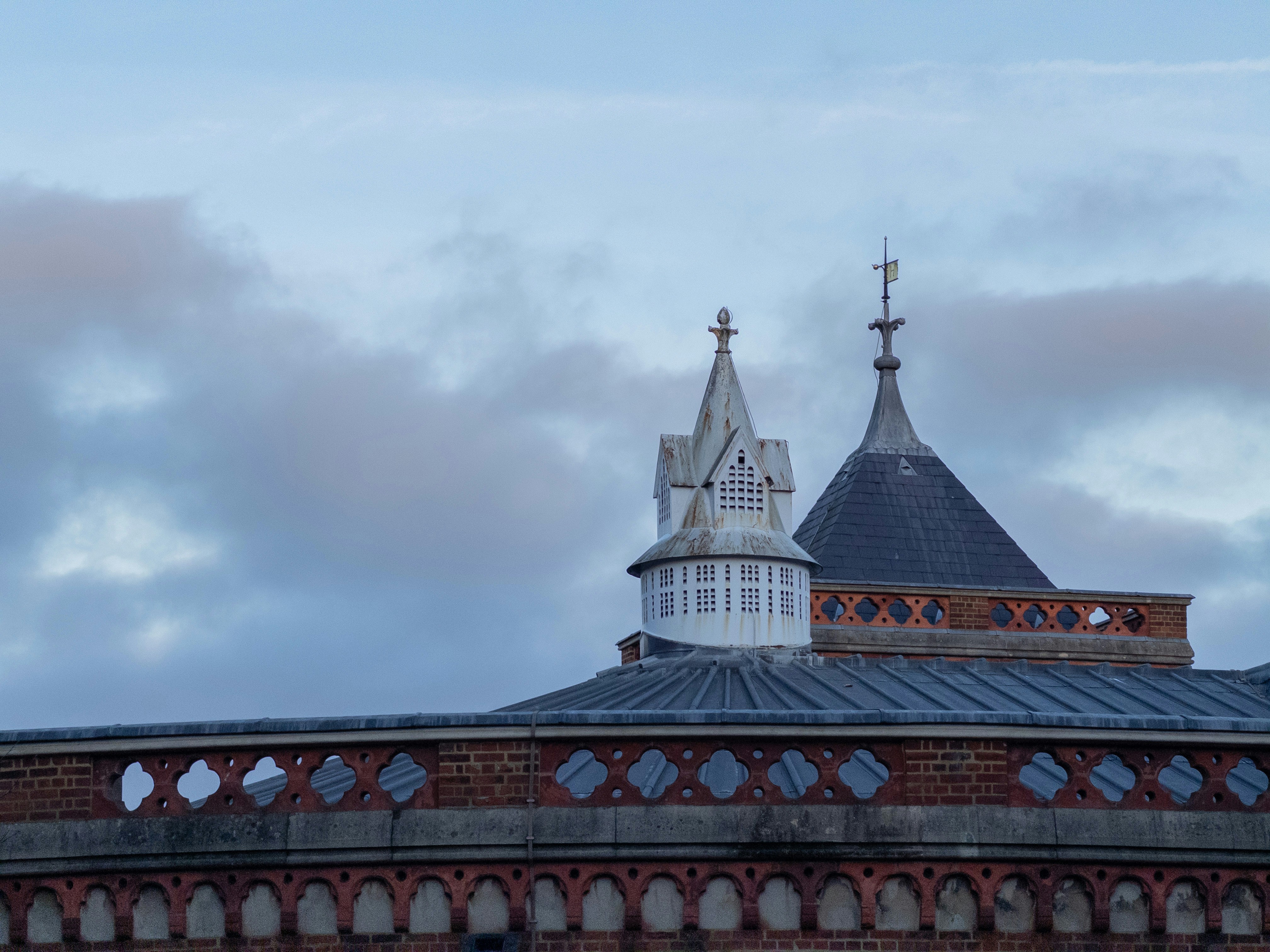 Ornate rooftops and spires against a cloudy sky