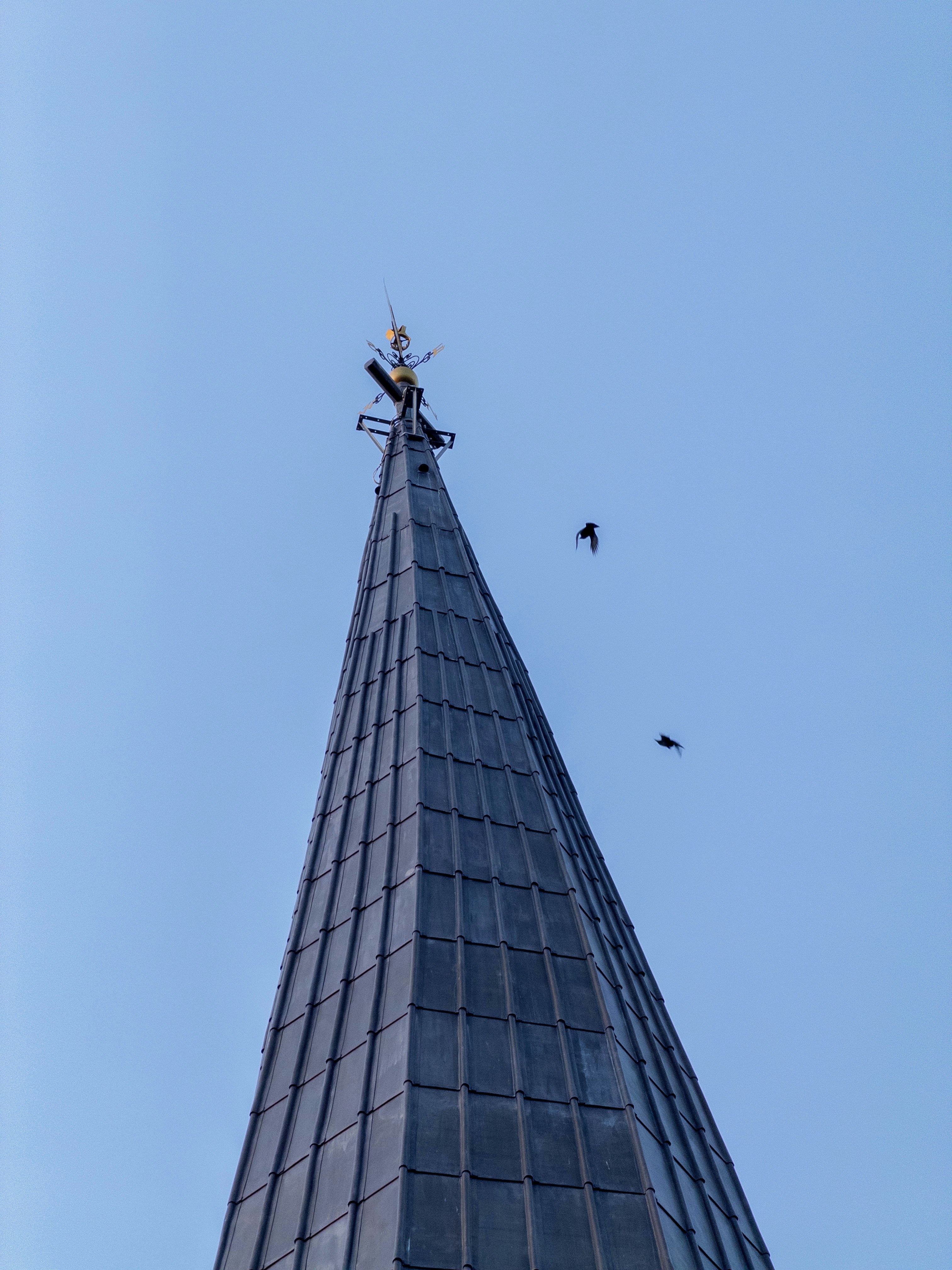 Tall dark spire reaching into a clear blue sky