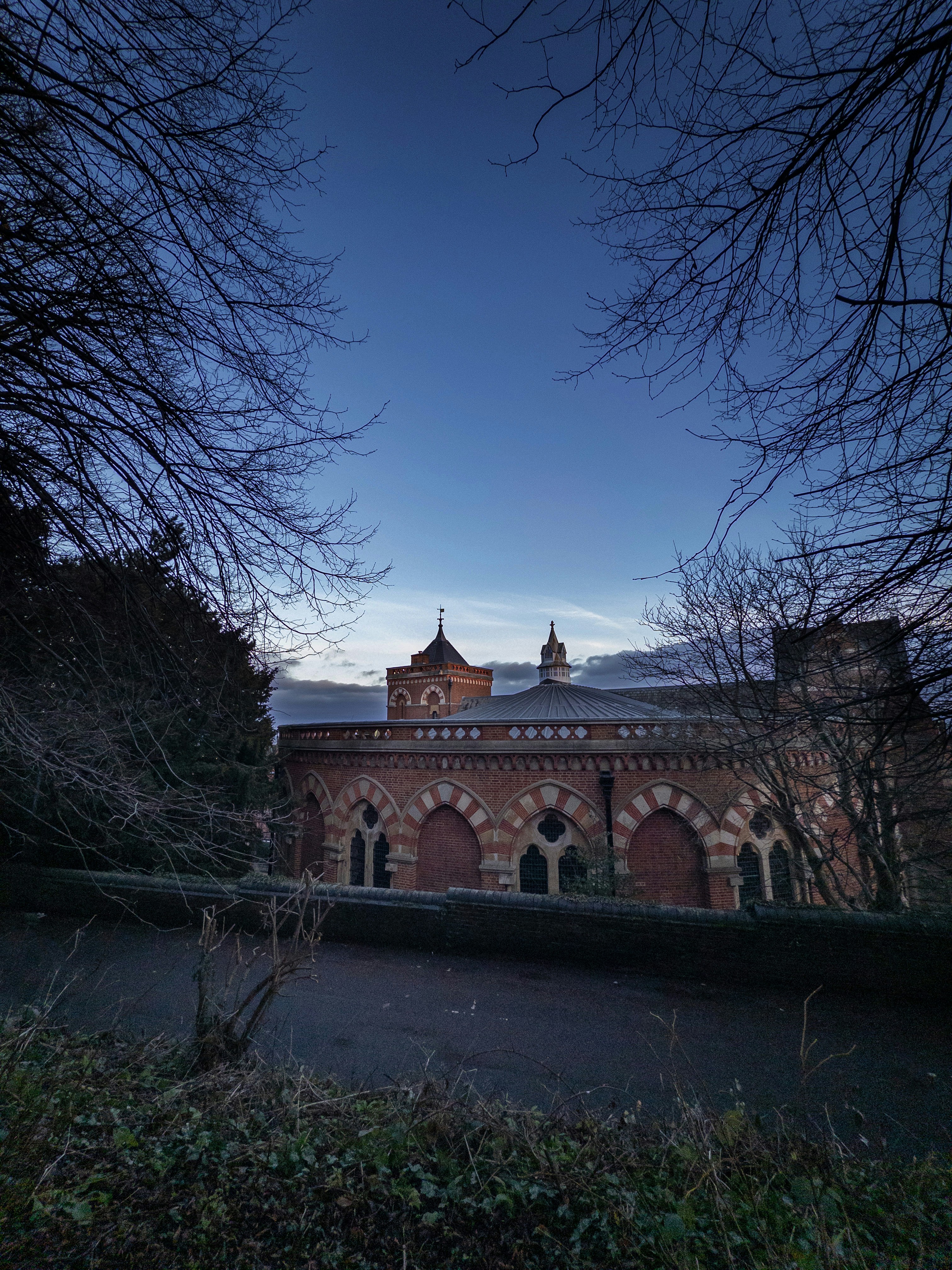 Historic building with arched windows under a twilight sky